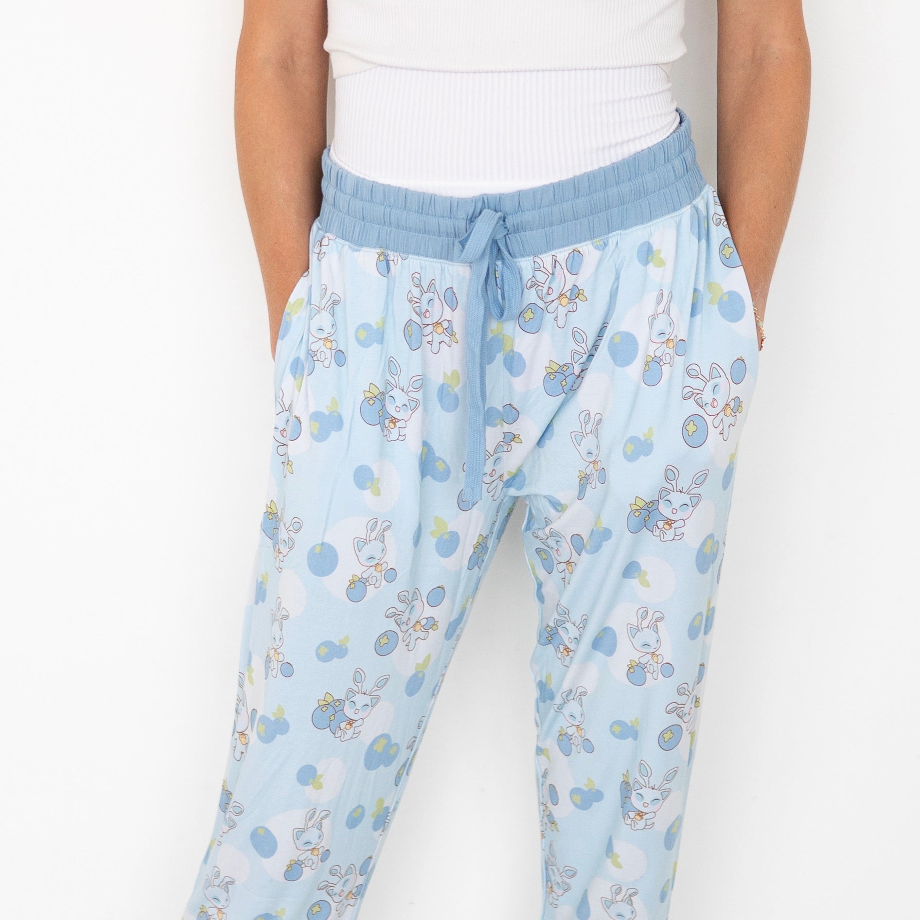 Women's light blue joggers with a Neopets blueberry baby print.