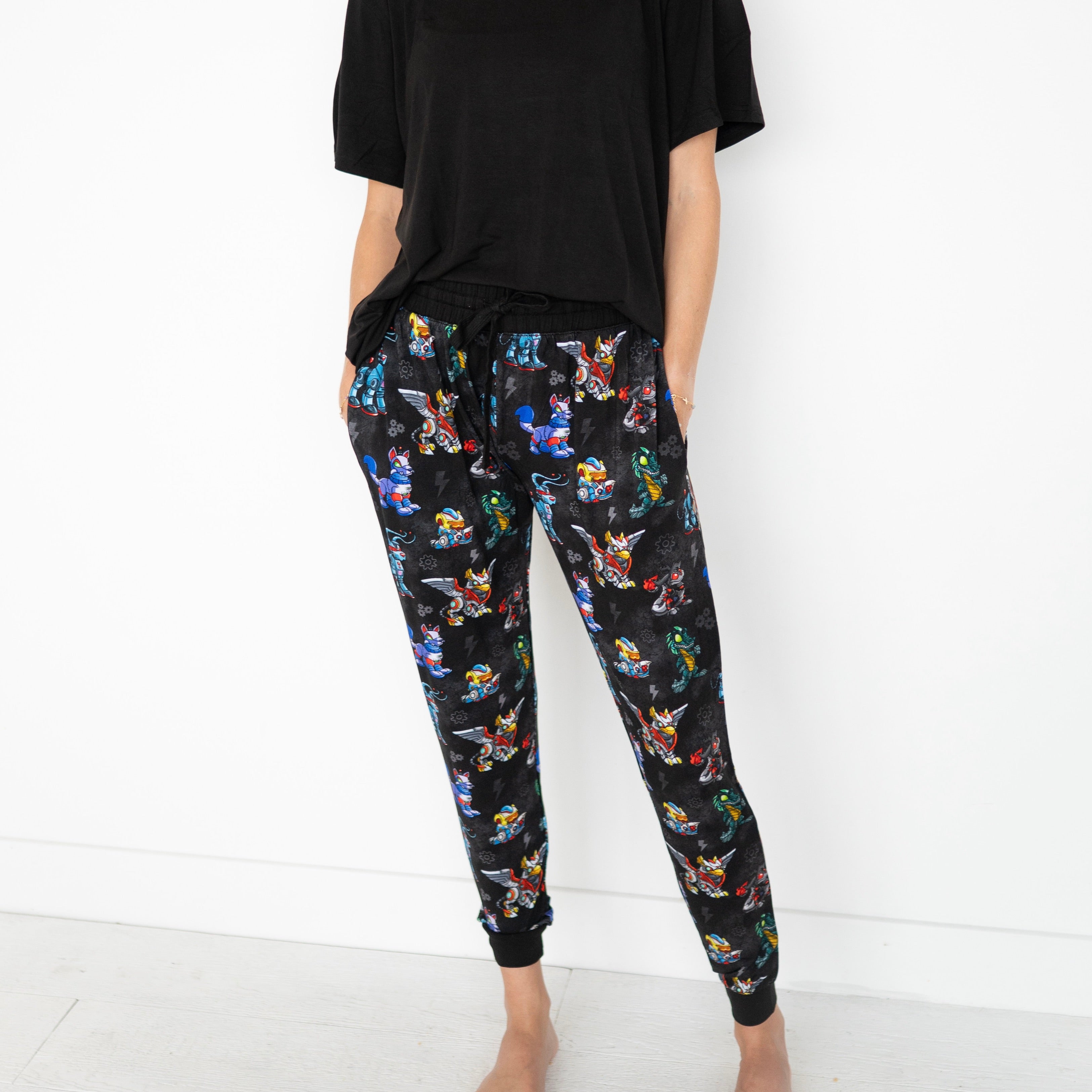 Women's black joggers with a Neopets robot print.