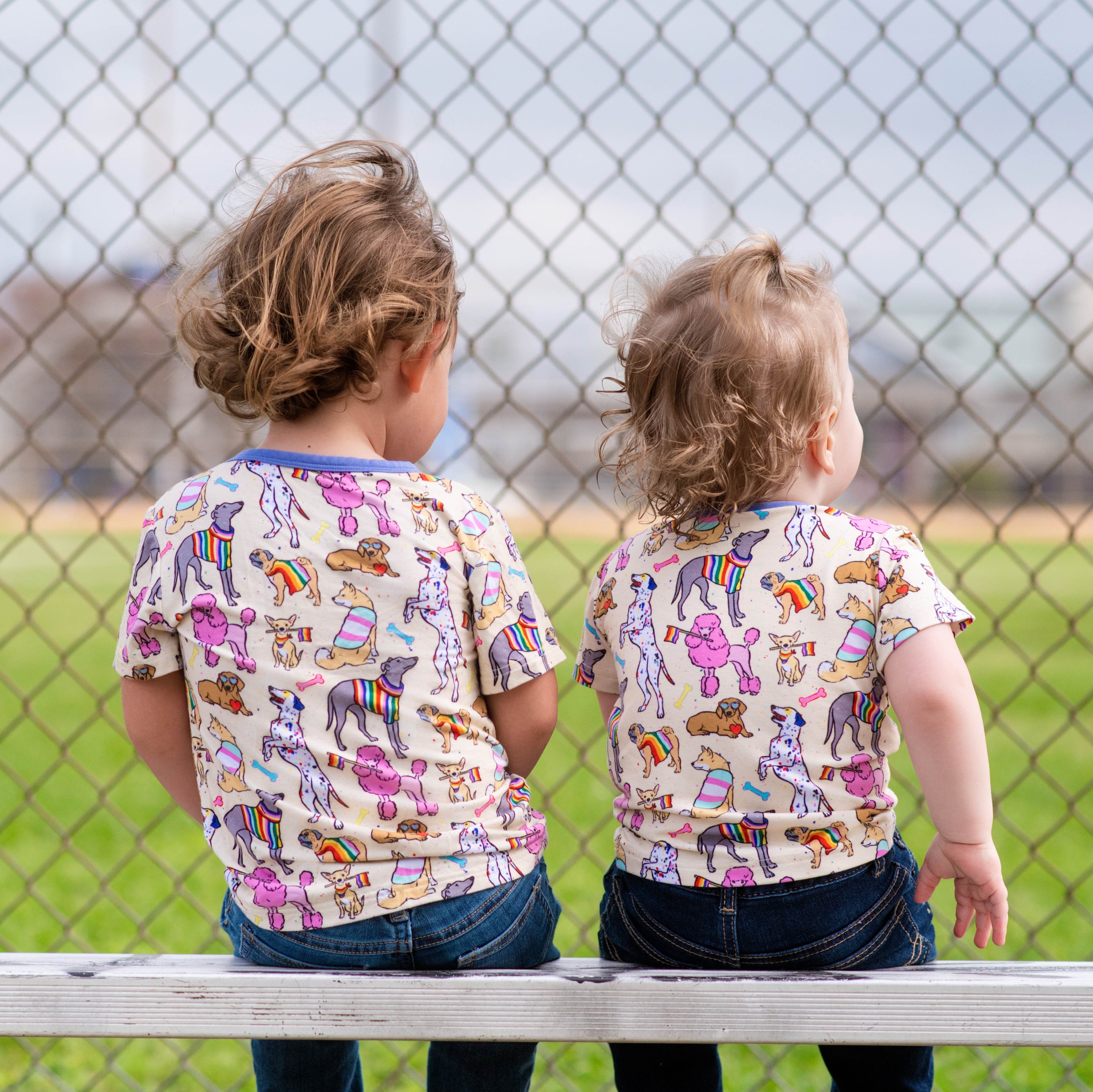 Kids t-shirt with a print of rainbow dogs and bones.