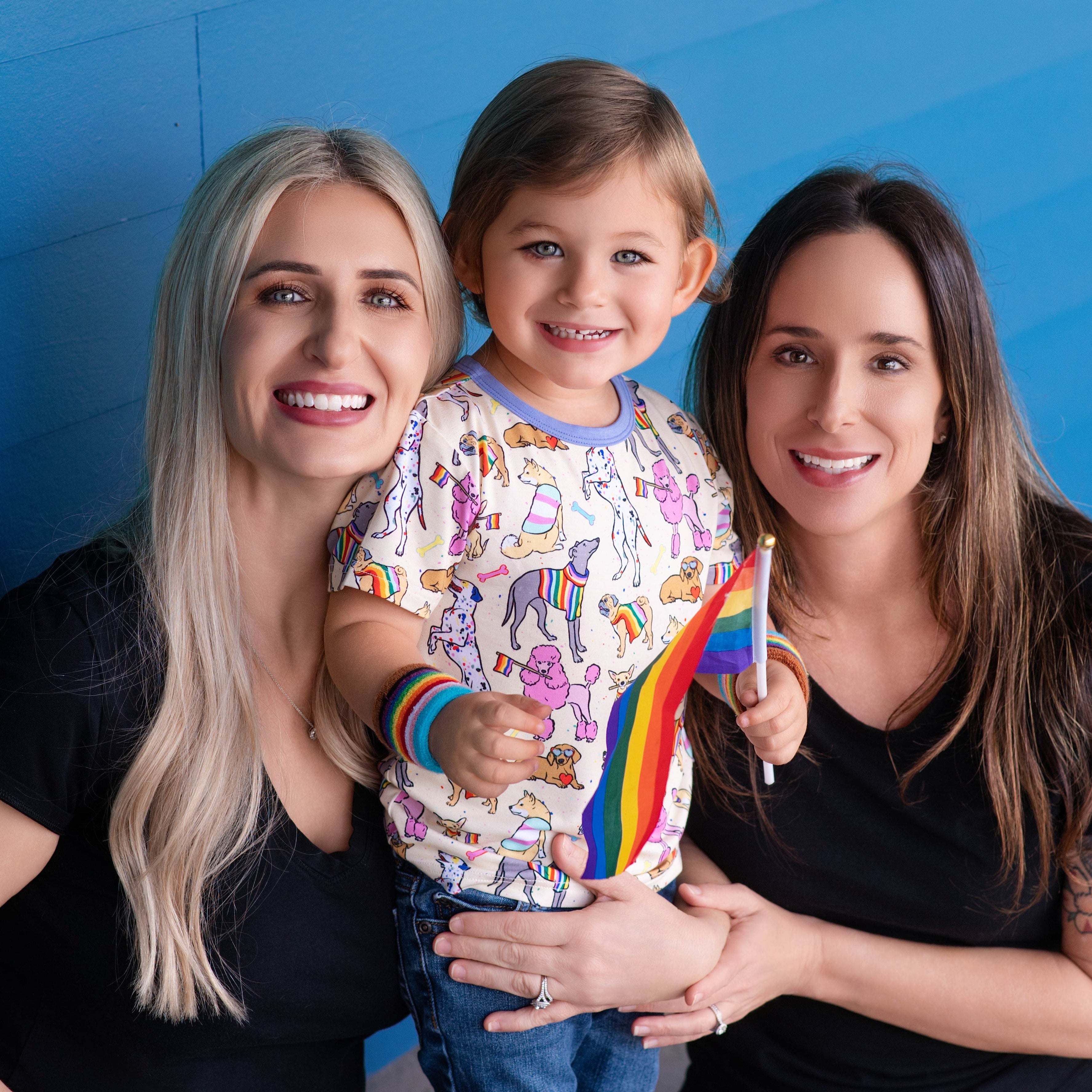 T-shirt with a print of dogs wearing rainbow colors.