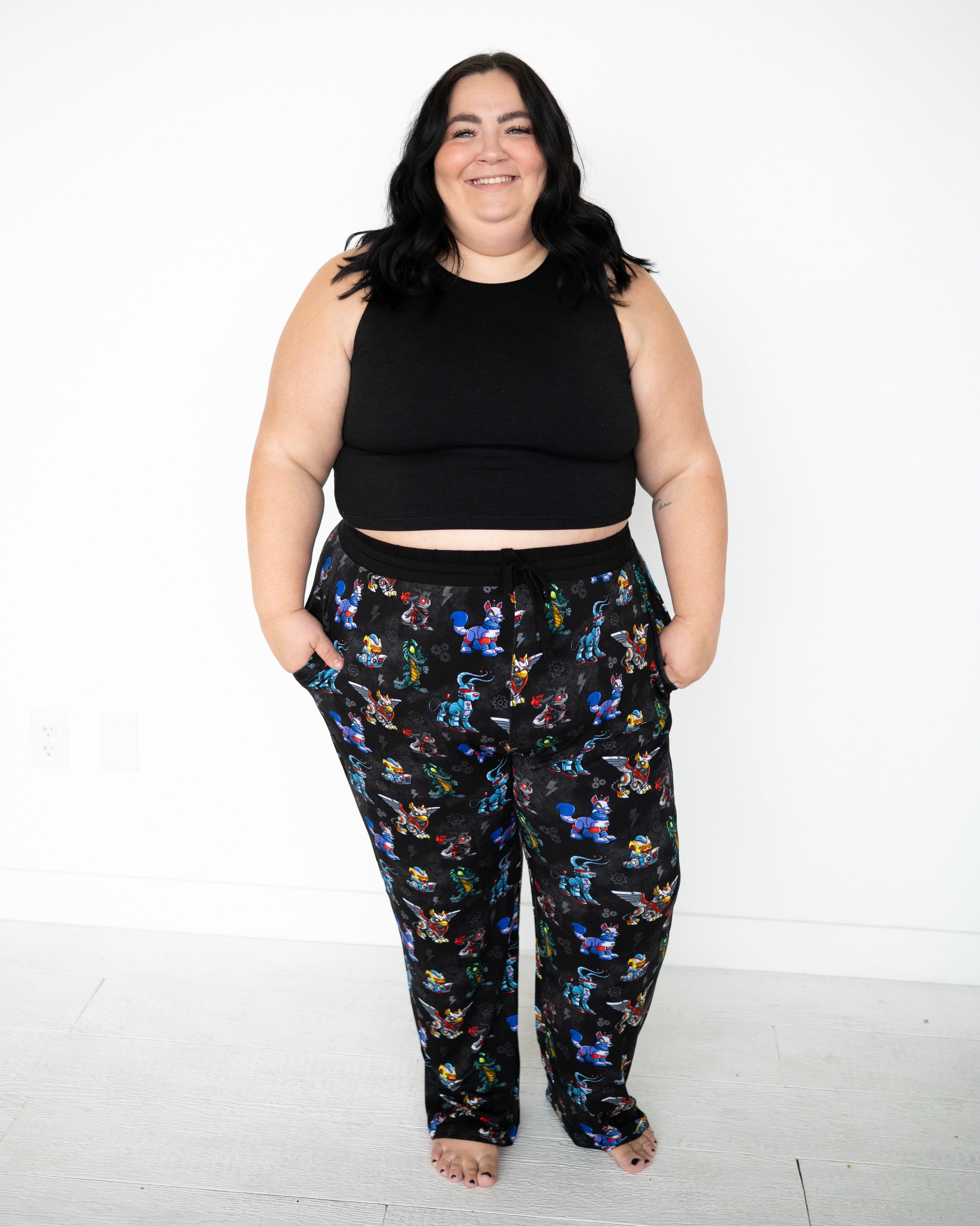 Unisex adult sleep pants with a black background and a colorful Neopets robot print.