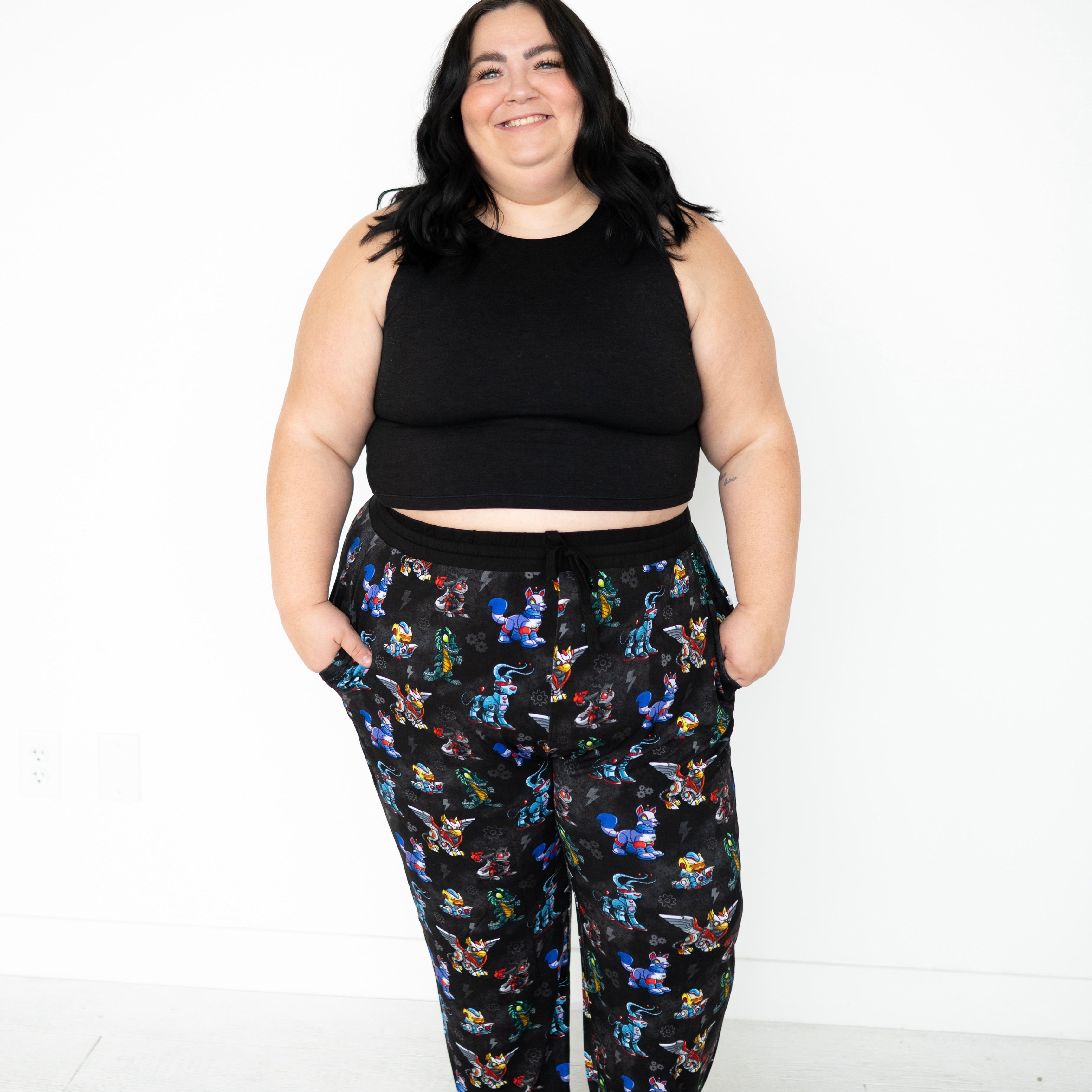 Unisex adult sleep pant with a black background and a colorful Neopets robot print.