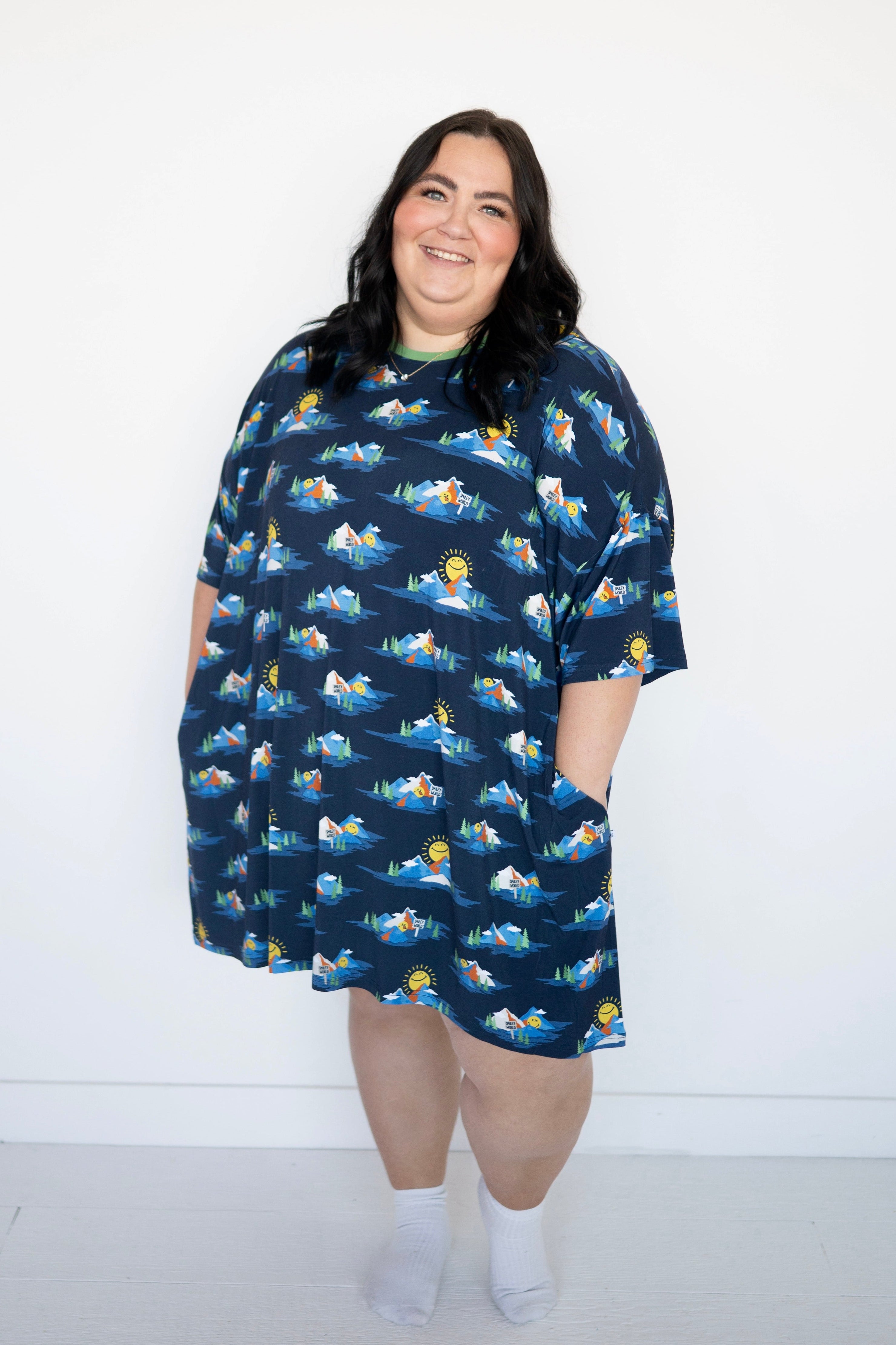 A navy blue oversized t-shirt dress with a Mount SmileyWorld print and pockets.