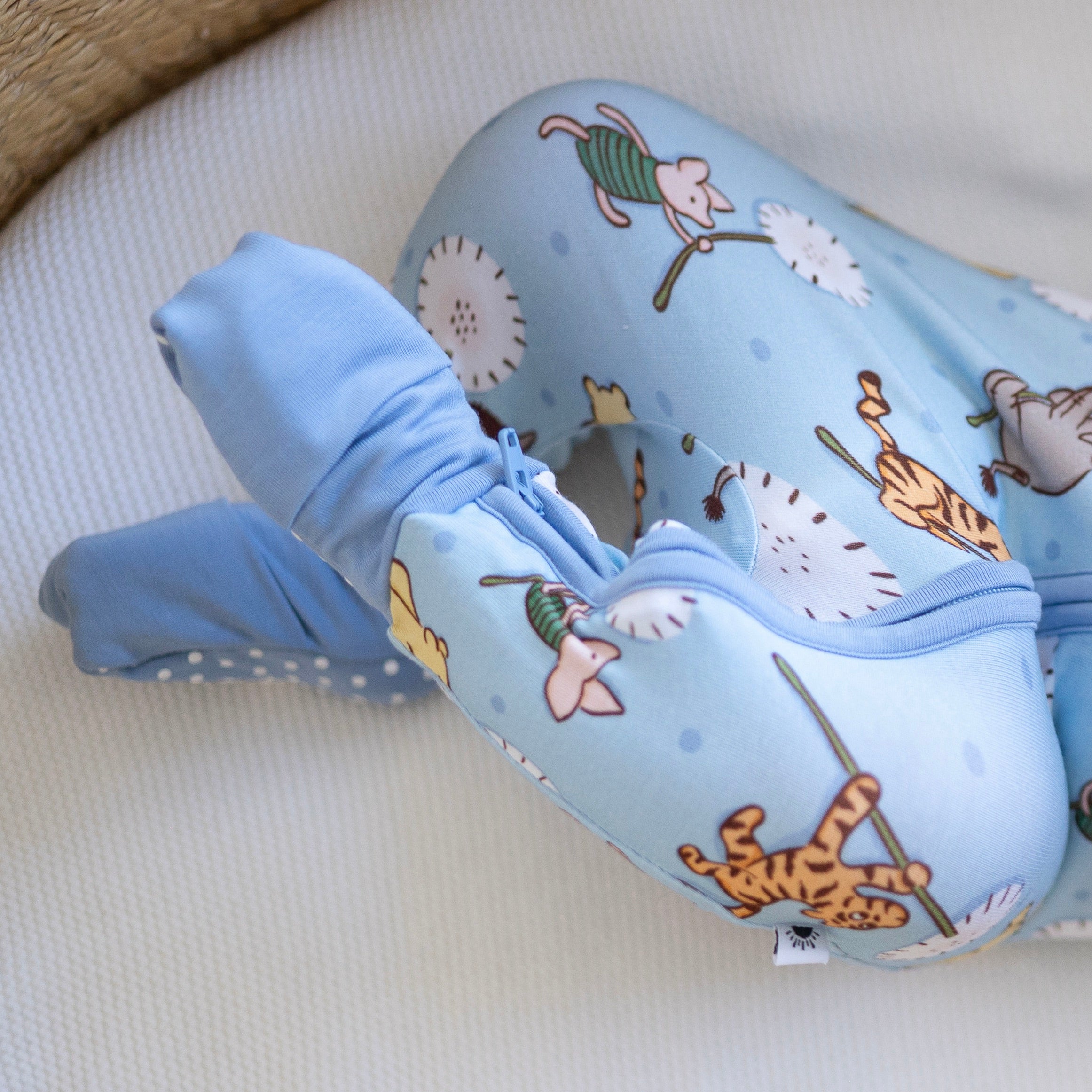 A light blue baby sleeper with a Winnie the Pooh "Fly Away, Pooh" print and a zipper.