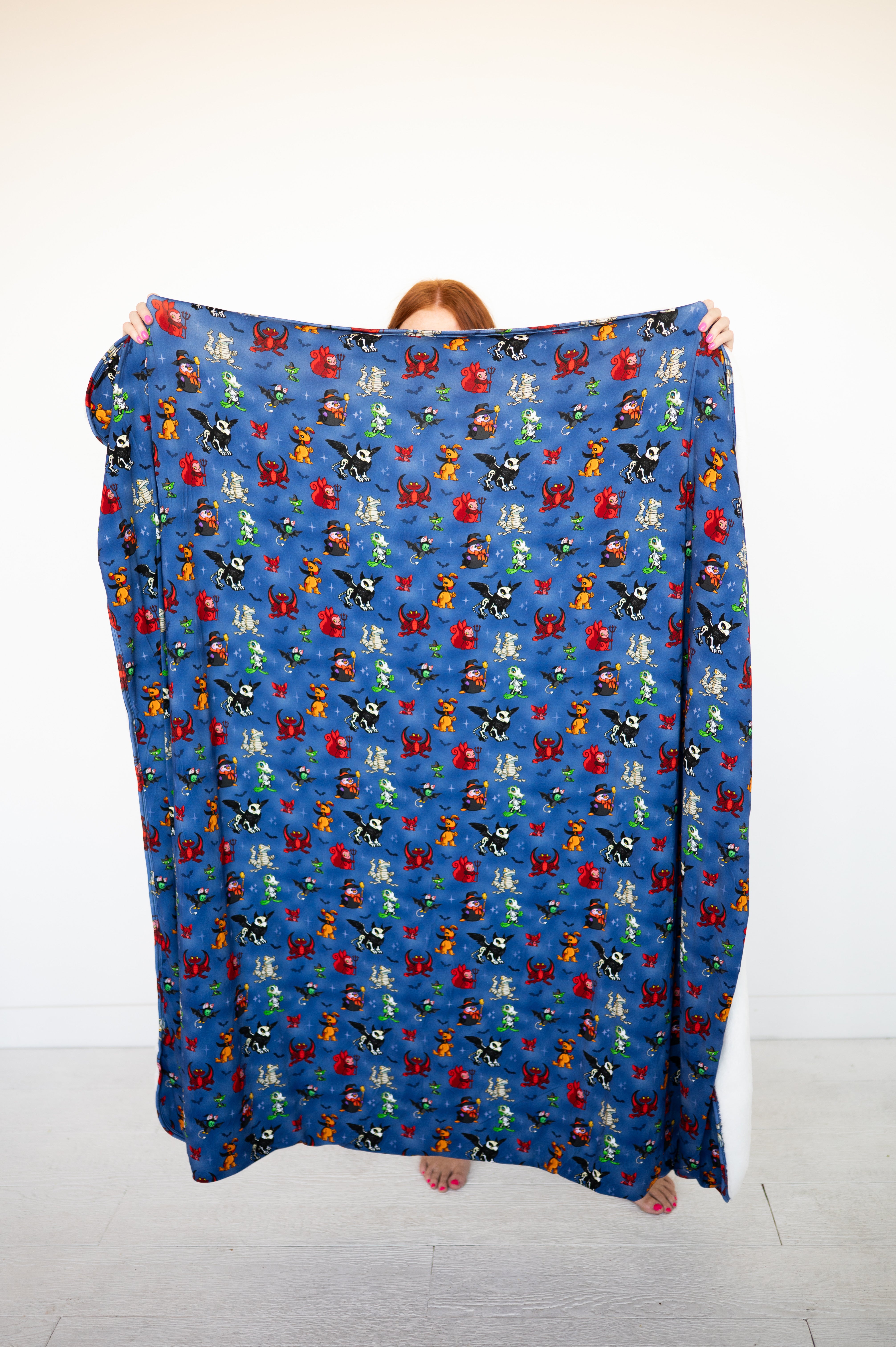 A blue blanket with a Halloween Neopets print.