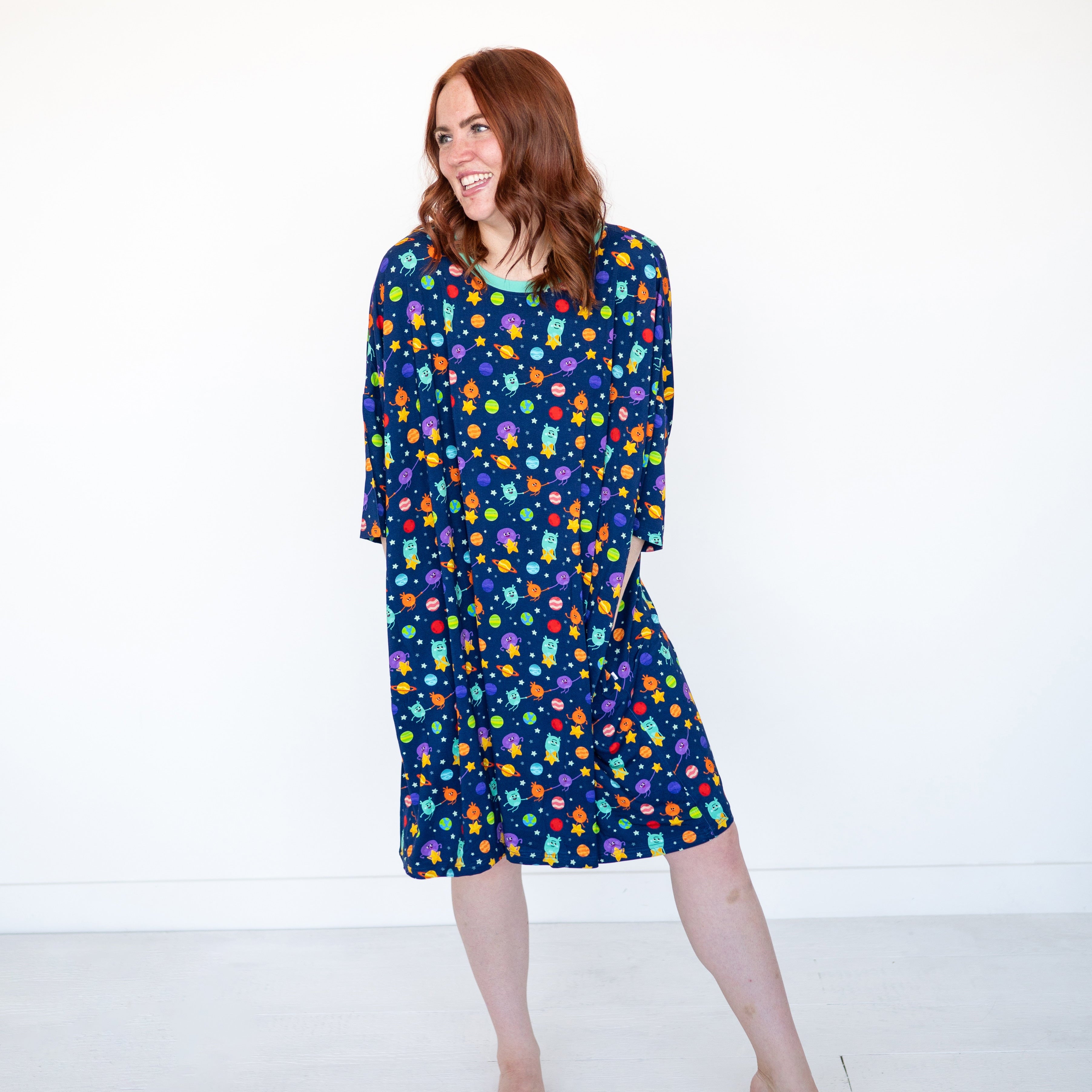 Adult mega sleep tee with a navy blue background and a colorful space-themed print.