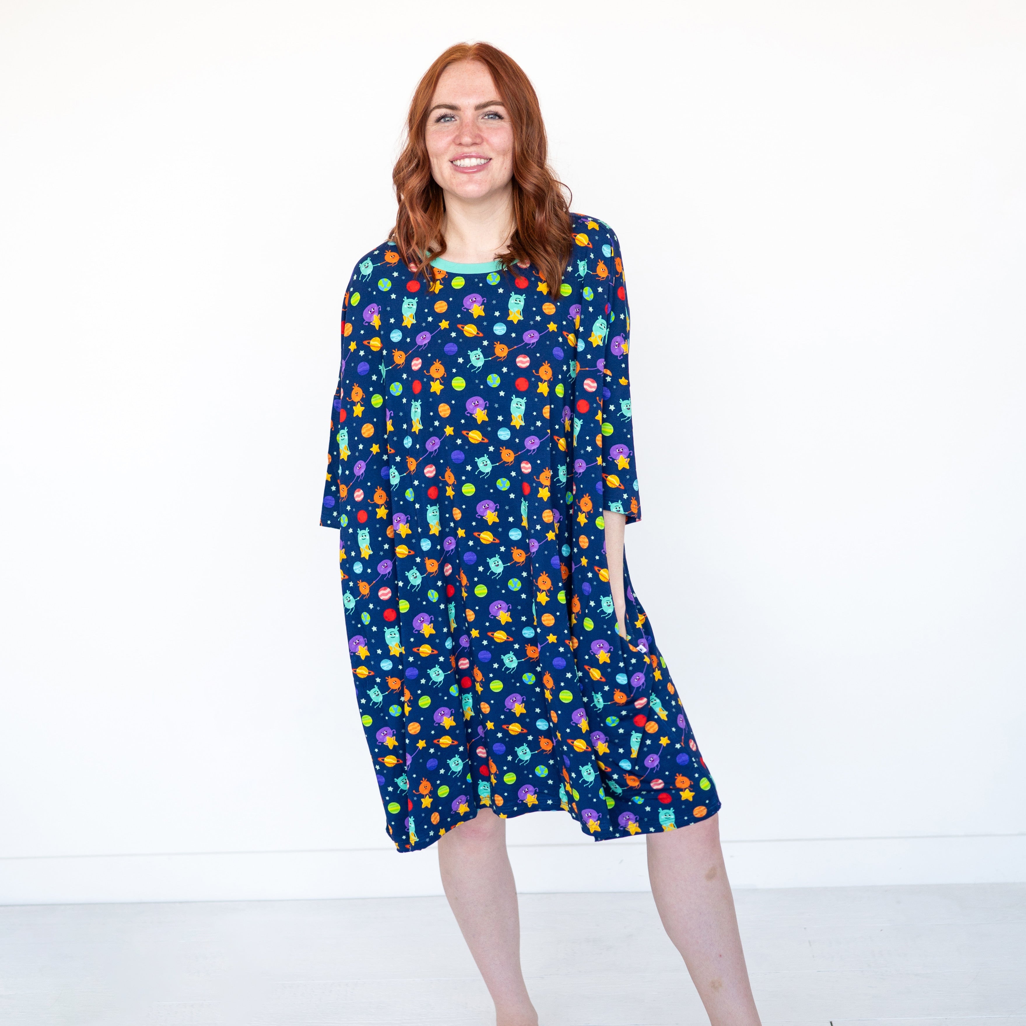 Adult mega sleep tee with a navy blue background and a colorful space-themed print.