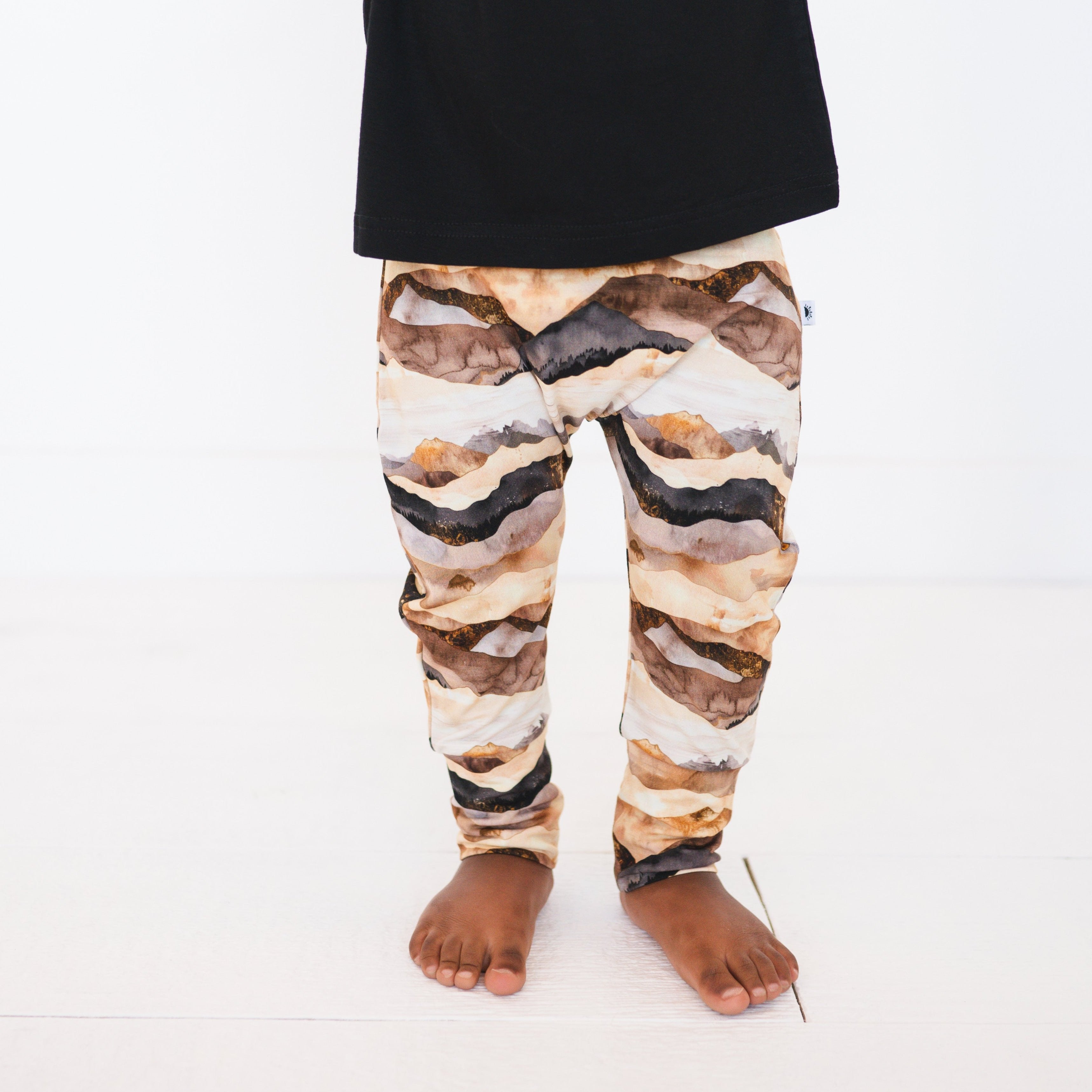 Luxe bamboo pants with a mountain range print and fold-over waistband and cuffs.