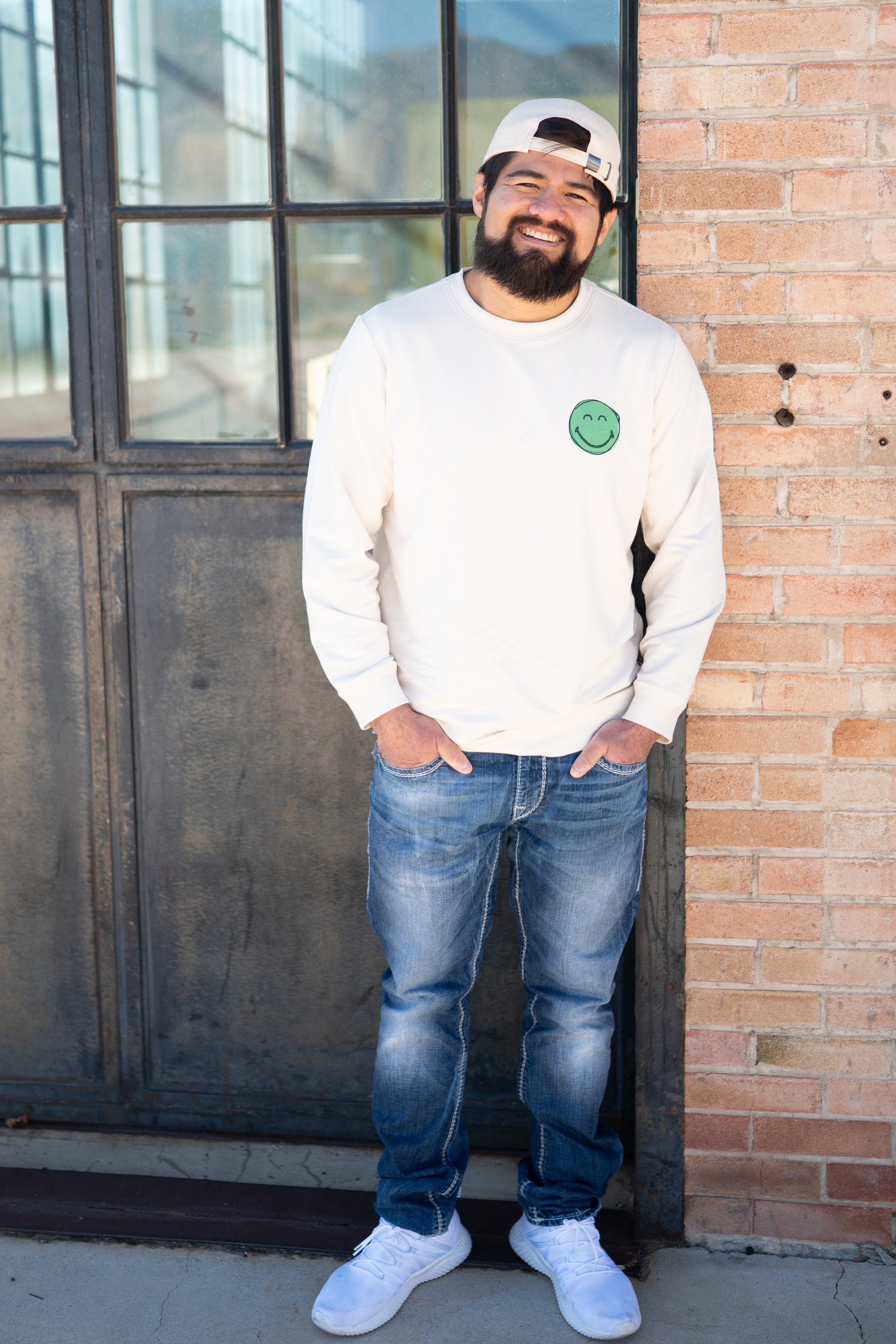 Adult unisex crewneck sweatshirt with a green smiley face graphic.