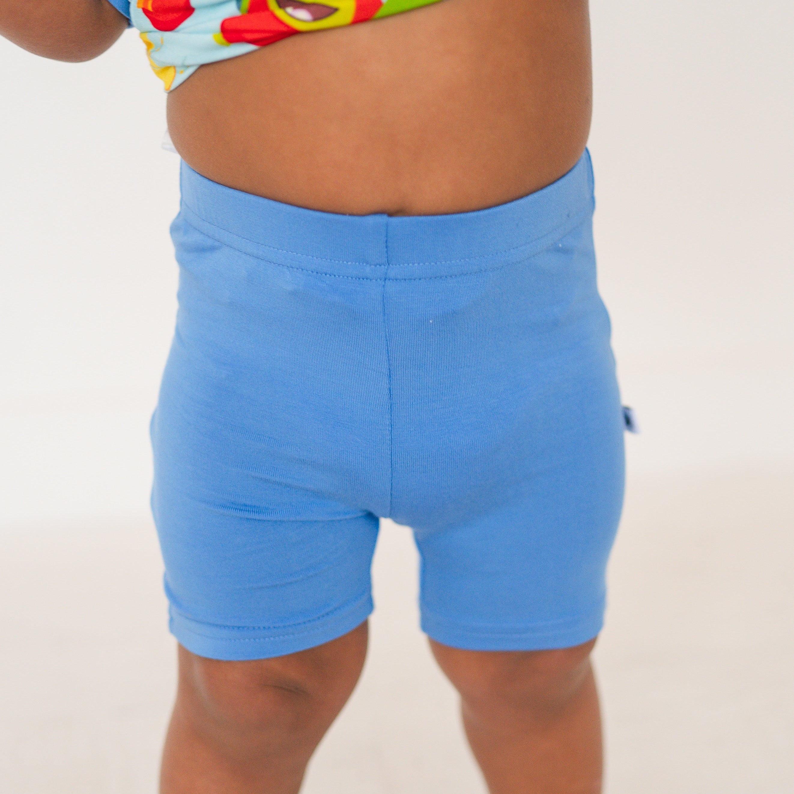 Blue biker shorts made of soft bamboo fabric with an apple and banana print.
