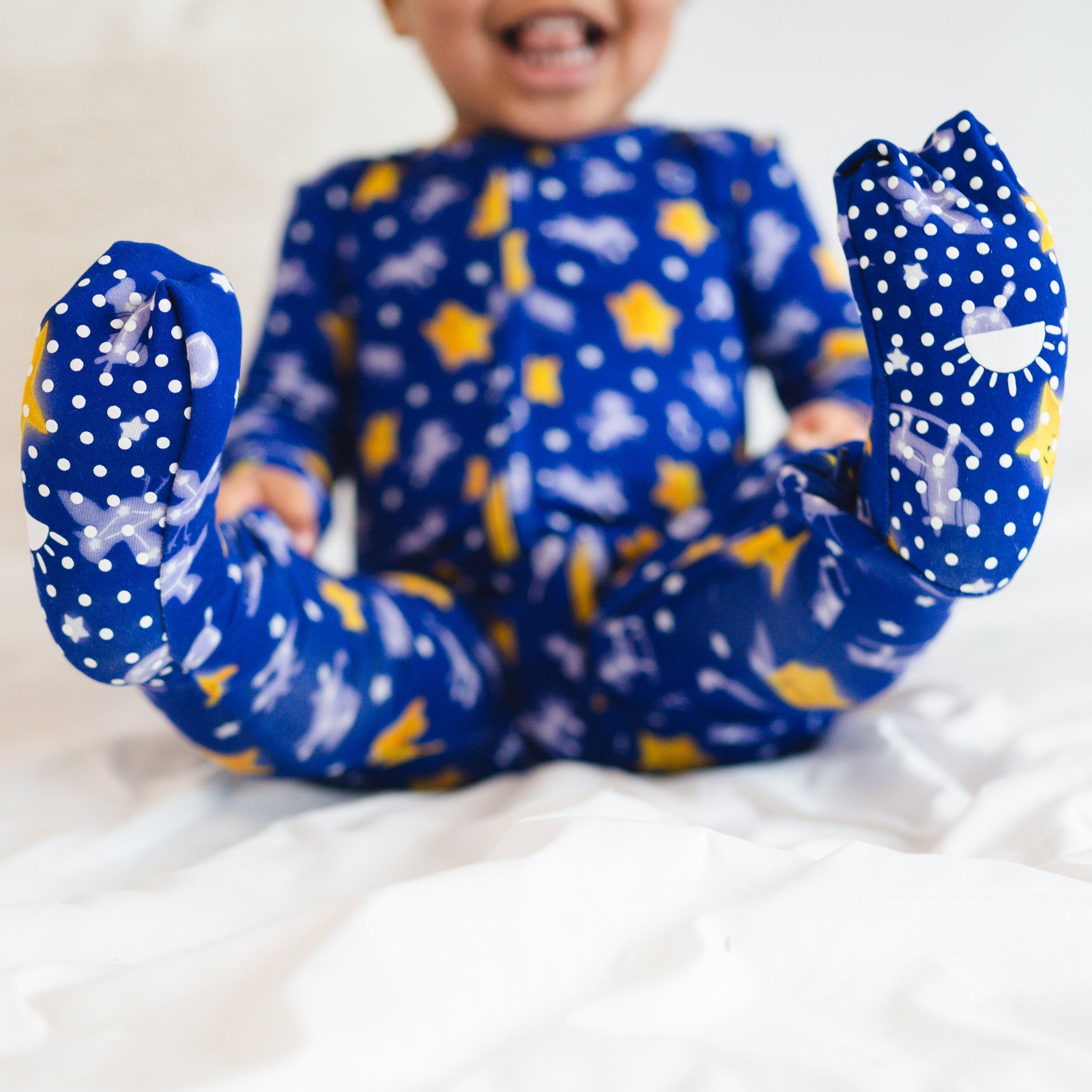 Blue bamboo pajamas with white polka dots and yellow stars.