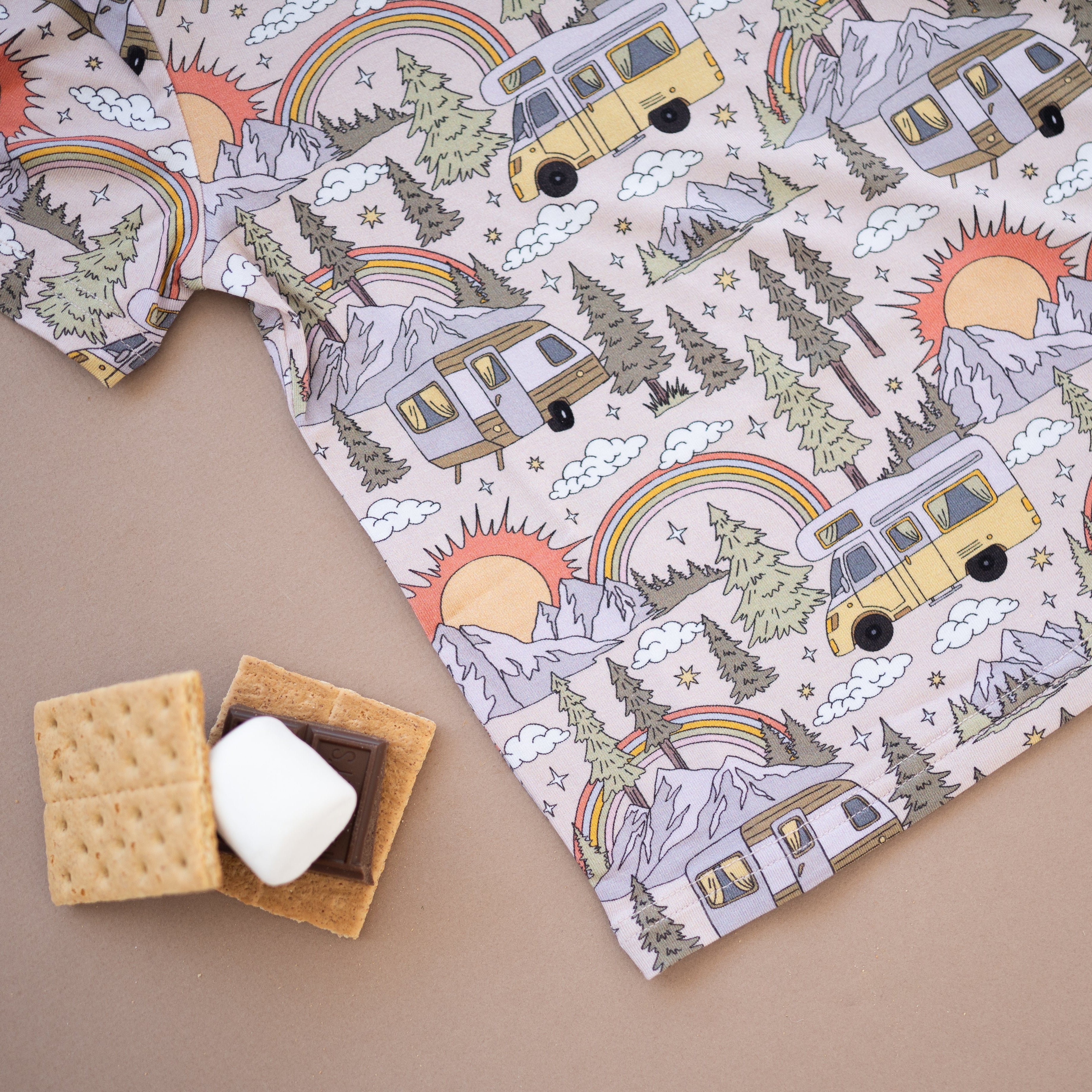 T-shirt with vintage camper, rainbow, and mountain print.