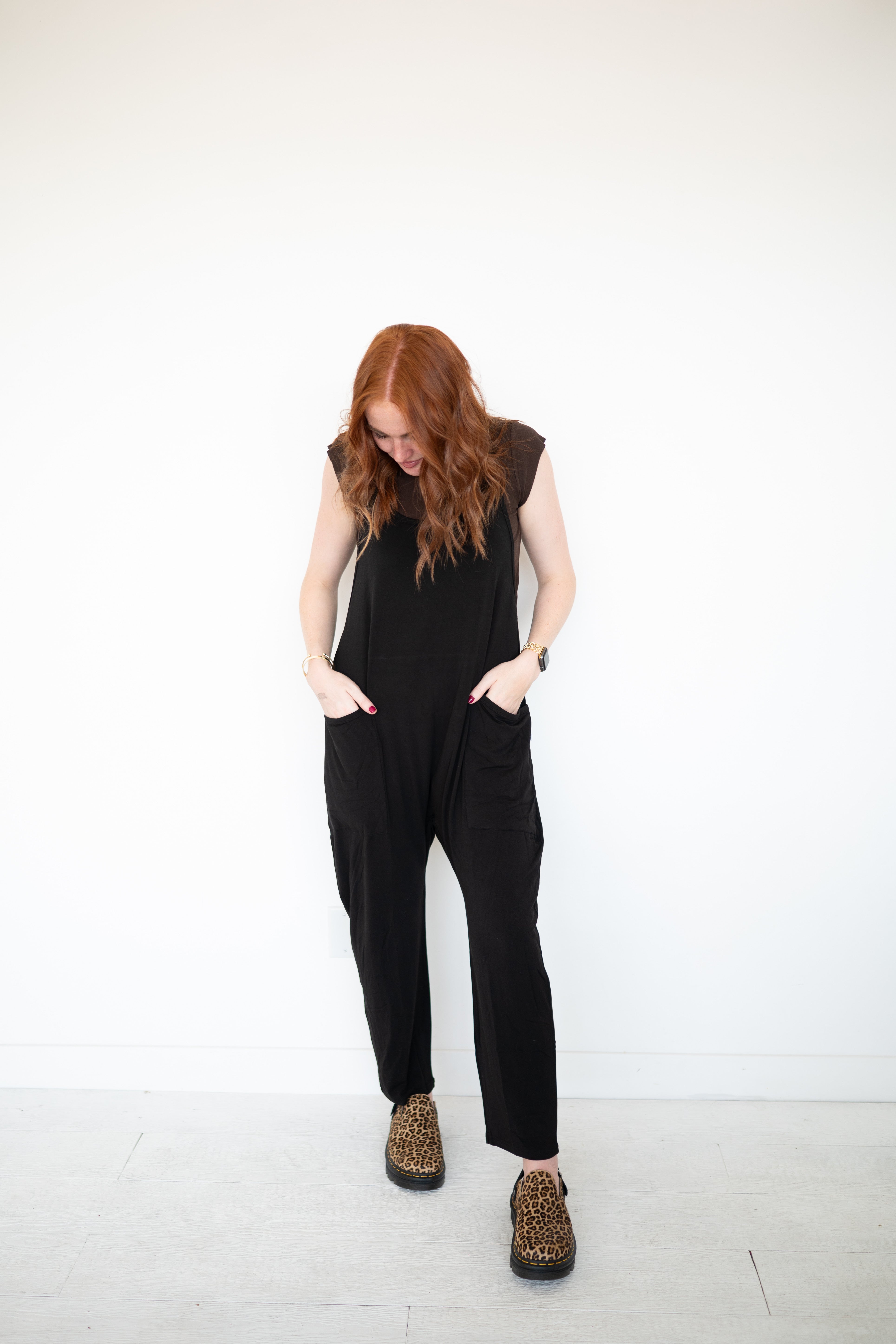 Black luxe bamboo overalls with oversized pockets and leopard print shoes.