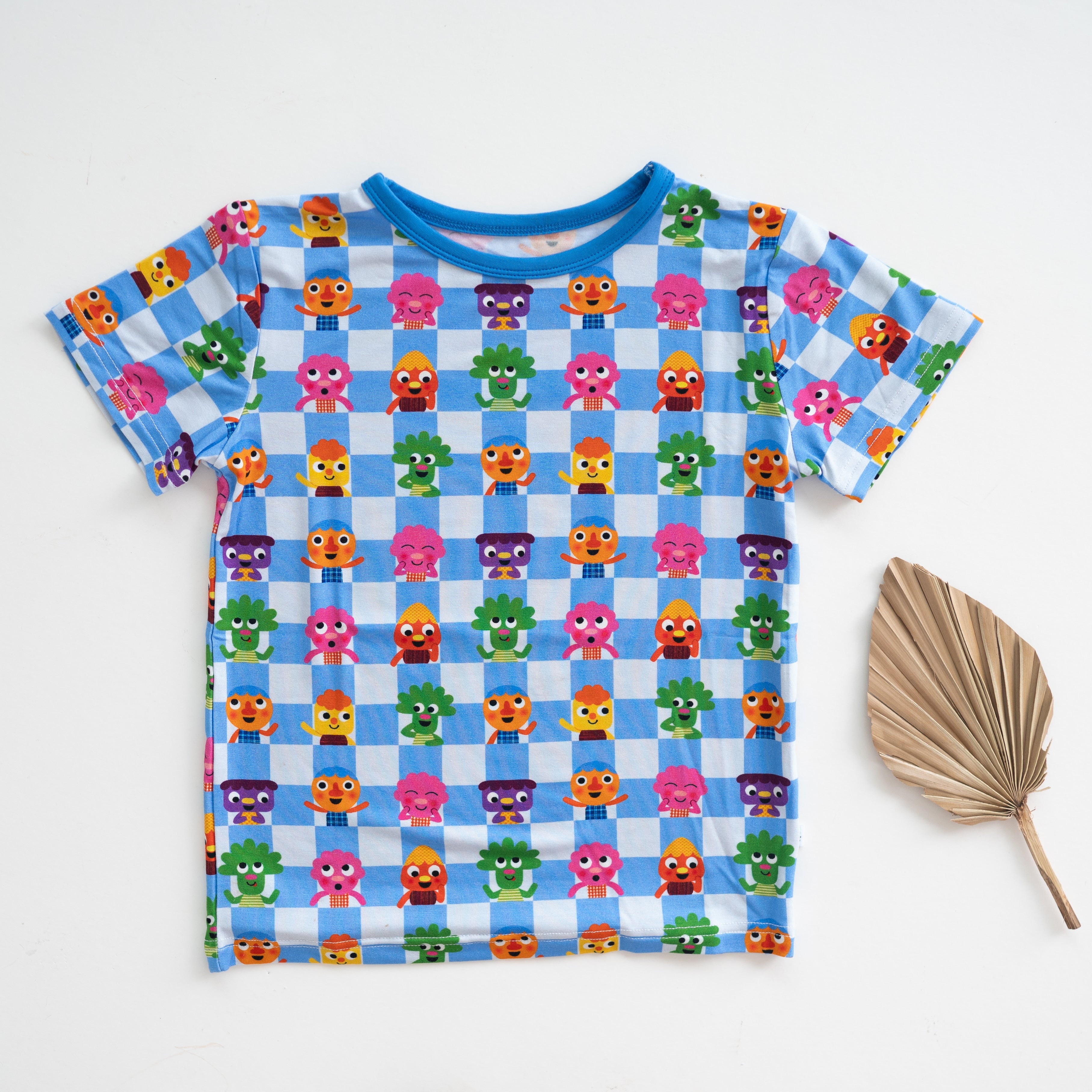 T-shirt with blue and white checkered pattern featuring cartoon characters.