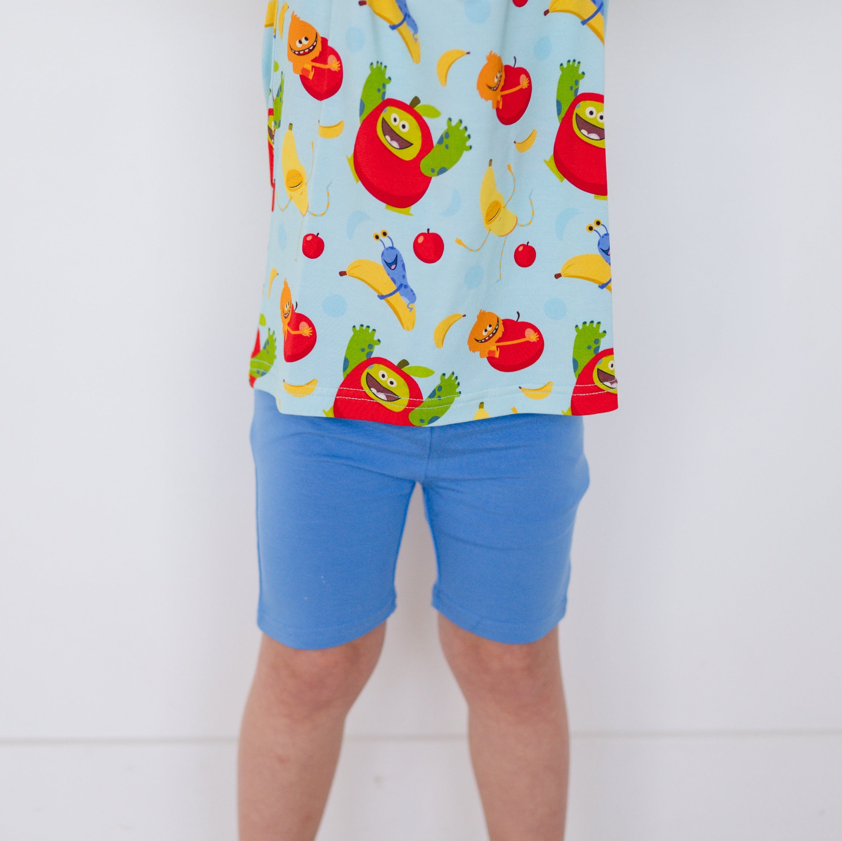 Blue biker shorts with a playful apples and bananas print.