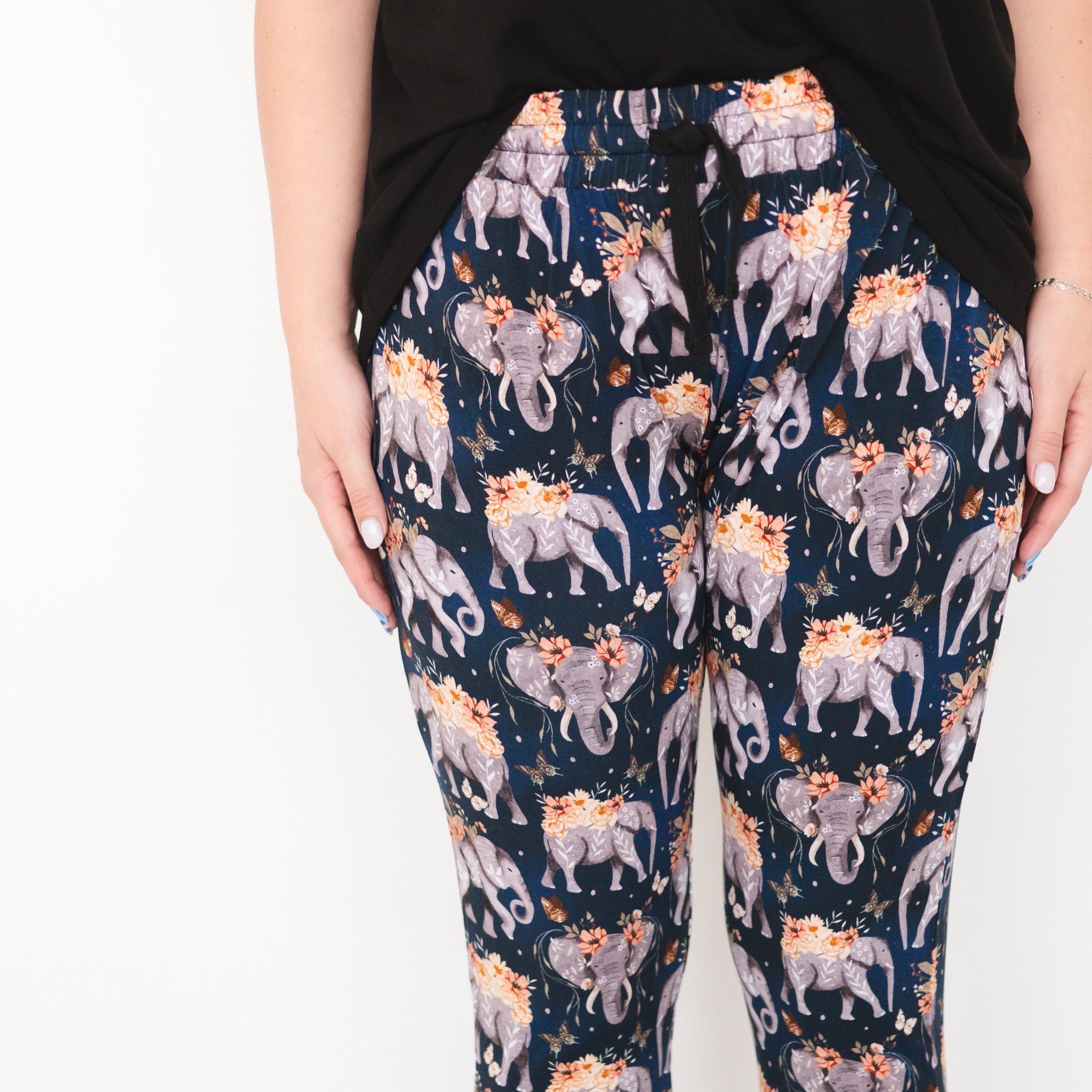 Women's navy joggers with an all-over elephant and floral print.