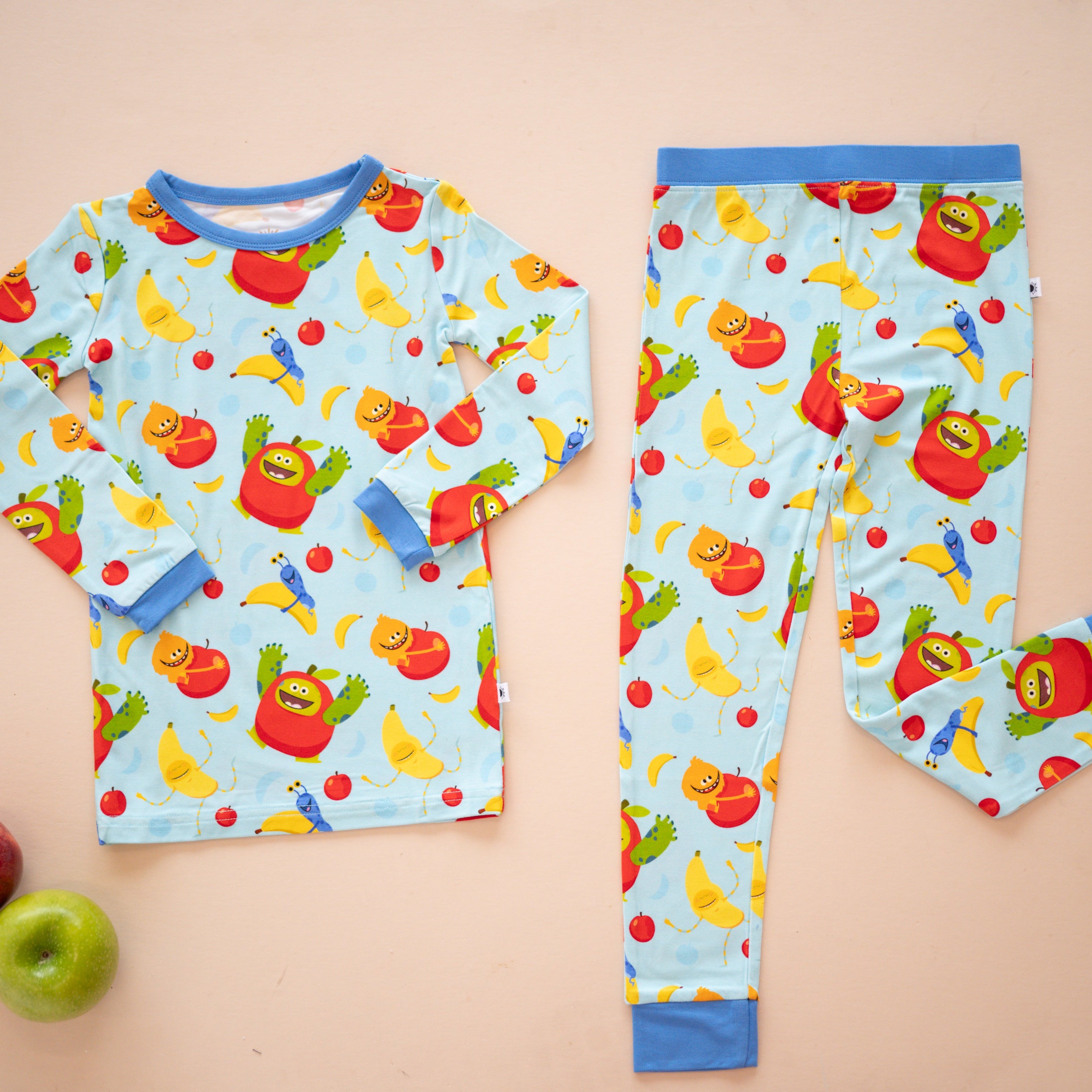 Light blue long-sleeved pajama set with an apples and bananas print.