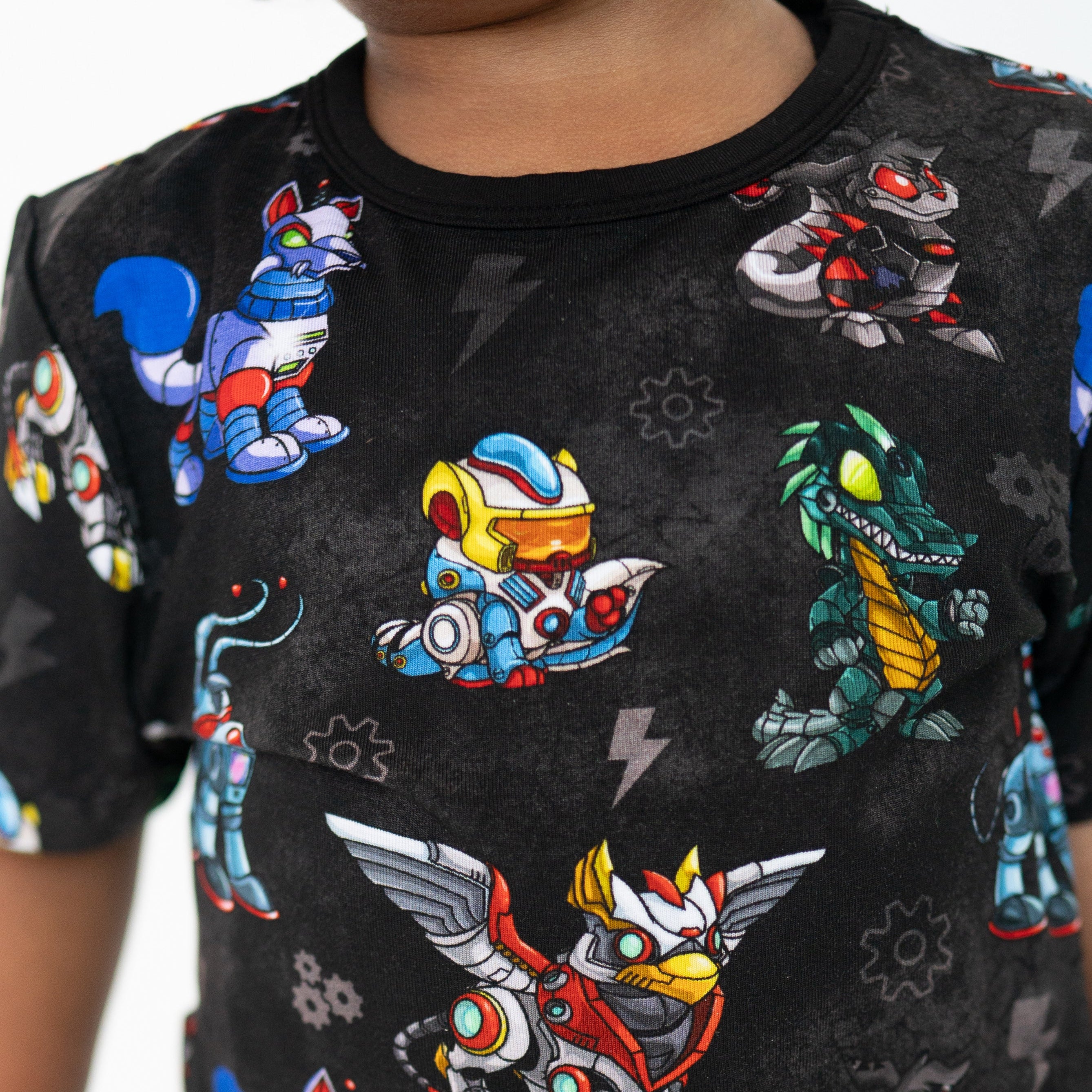 A black t-shirt with a pattern of colorful robot characters.