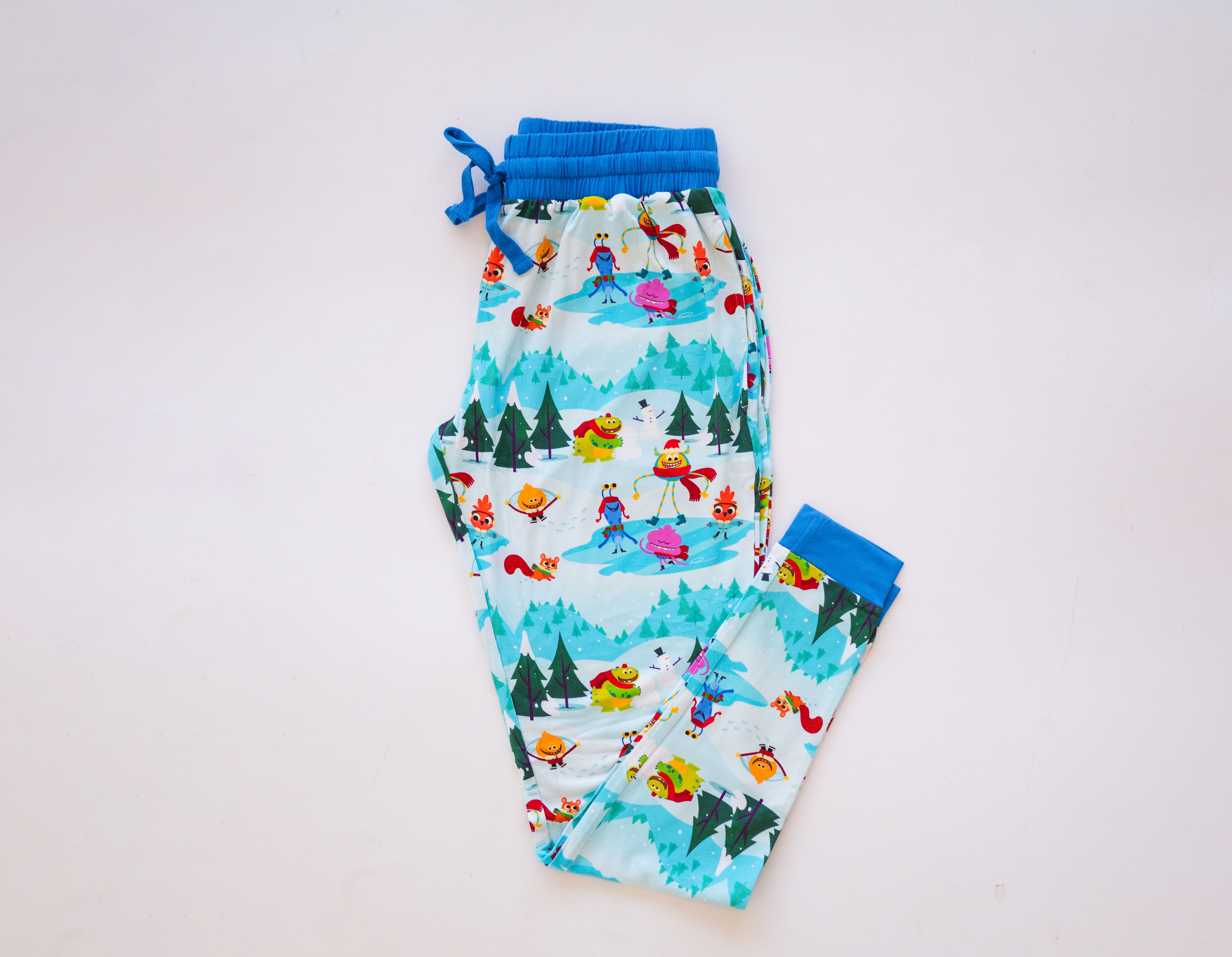 Light blue bamboo joggers with a "Snow Much Fun" print featuring cartoon characters.