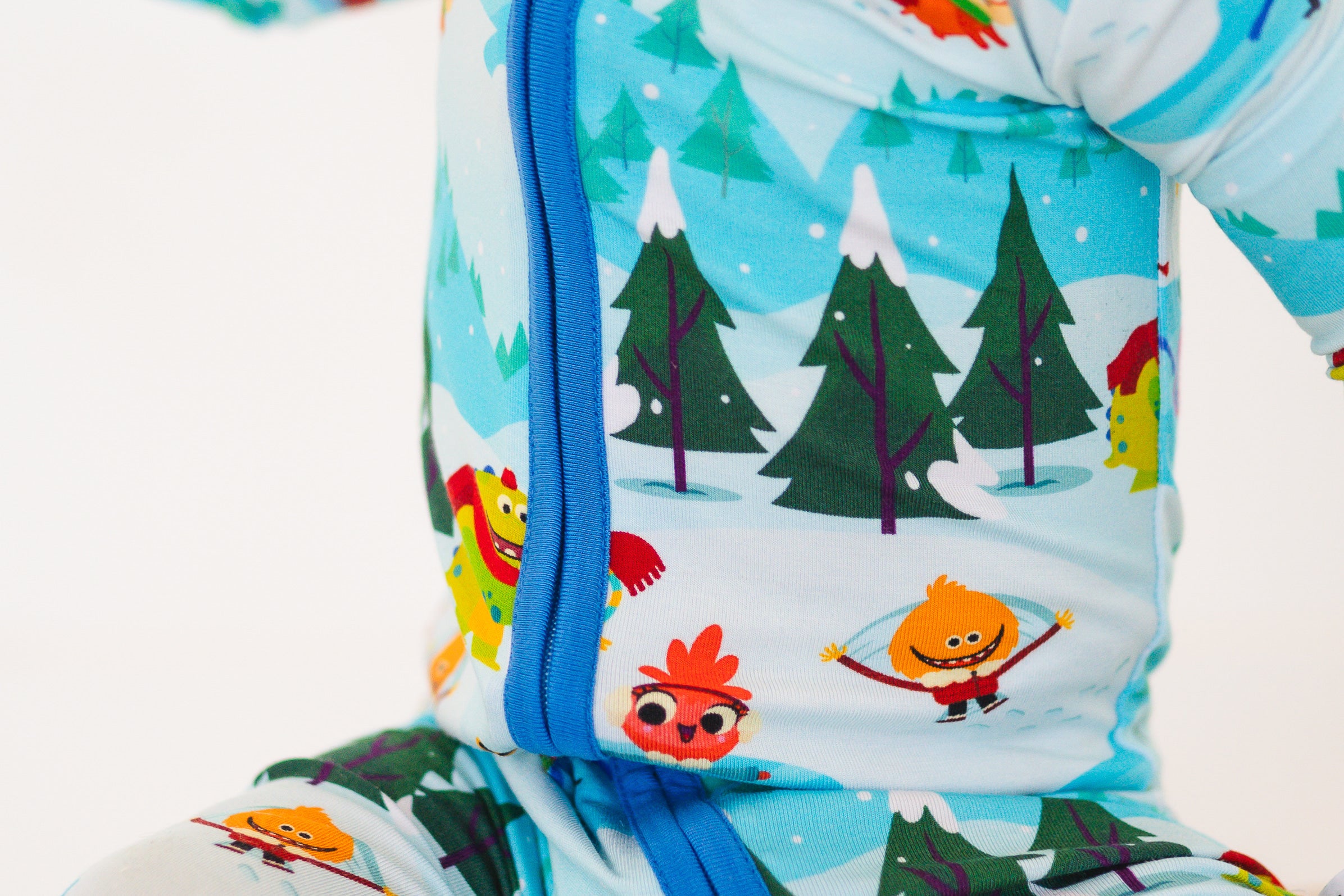A light blue bamboo pajama set with a winter scene and cartoon characters.