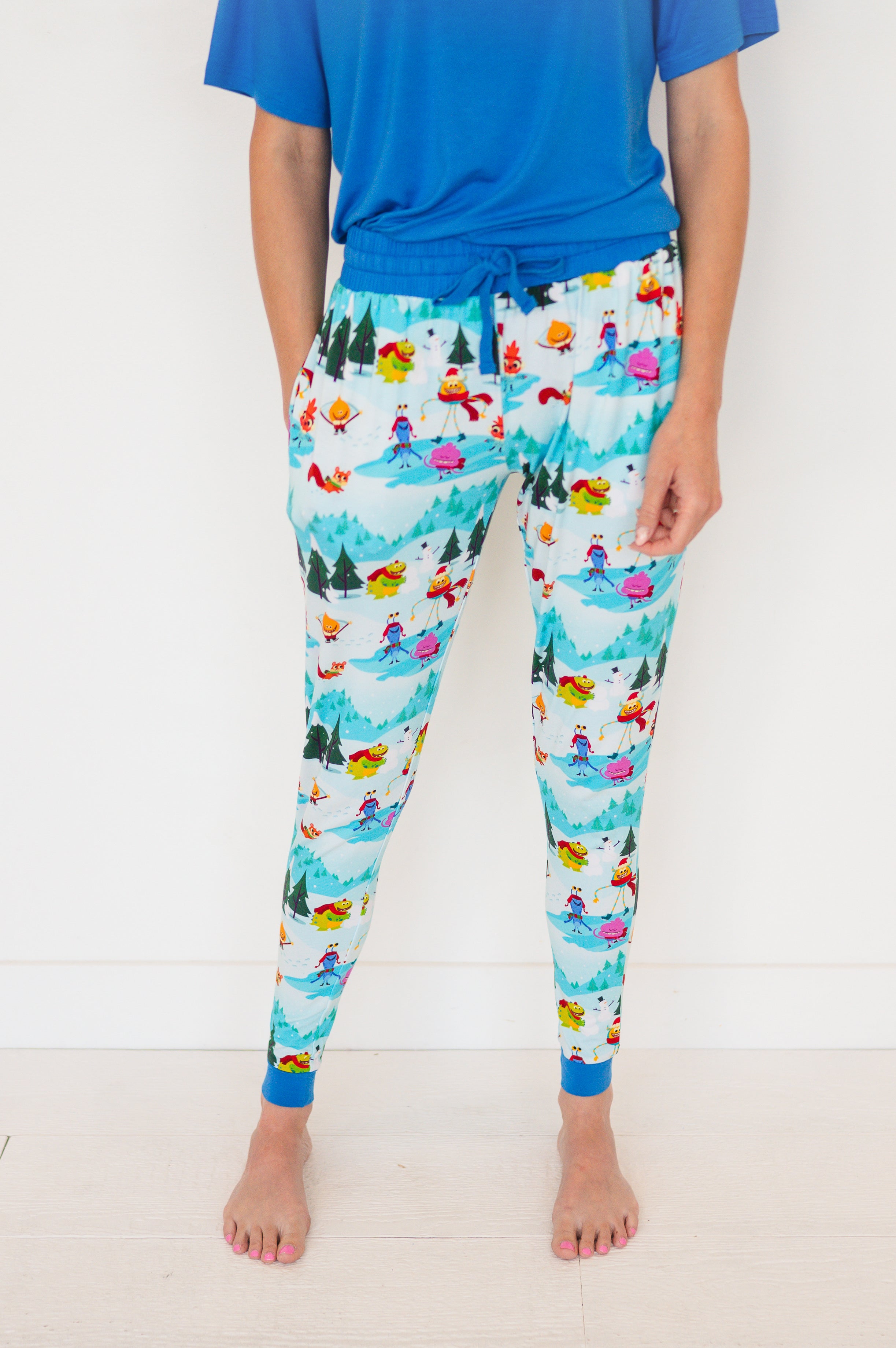 Women's light blue bamboo joggers with a playful snow-themed monster print.