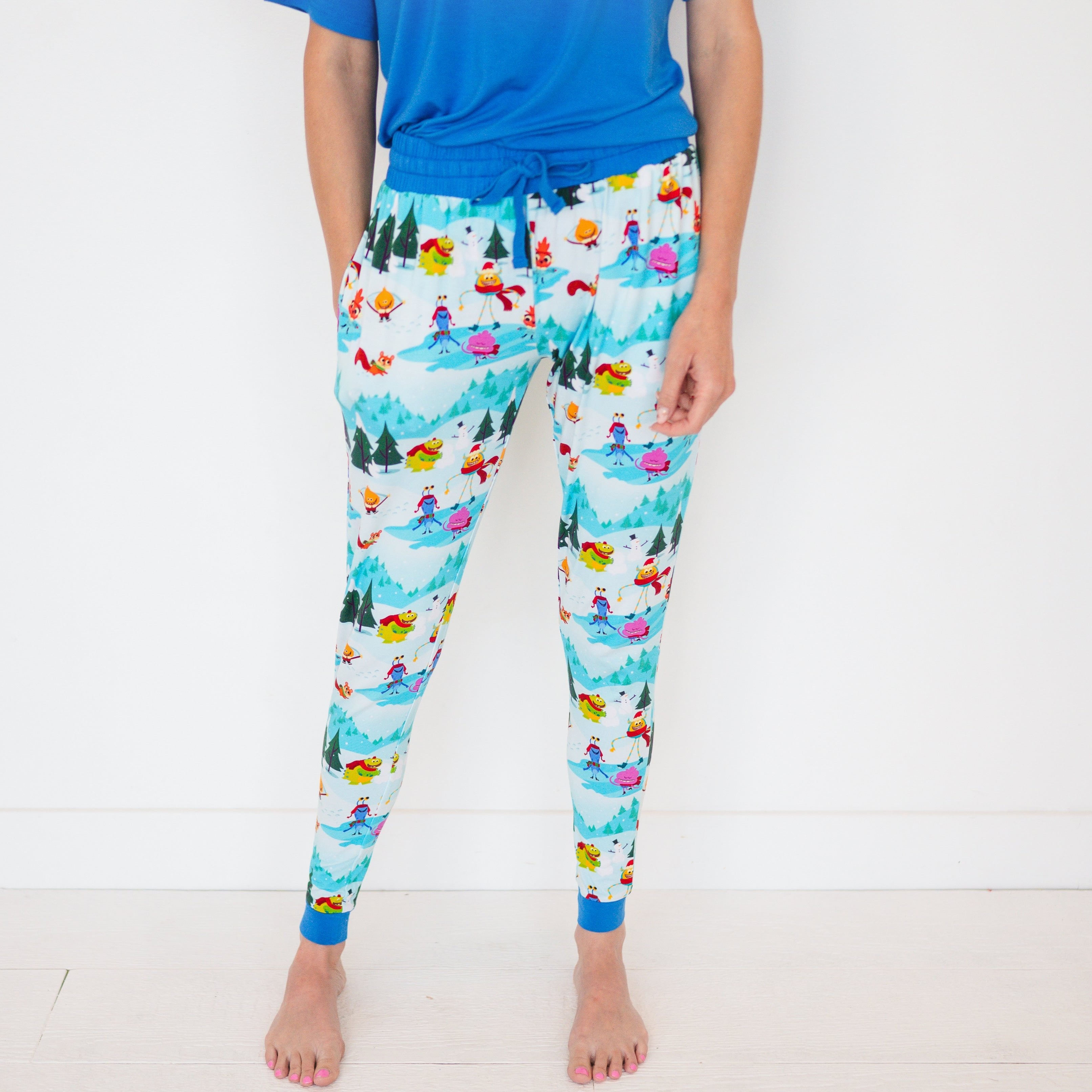 Women's light blue bamboo joggers with a "Snow Much Fun" cartoon print.