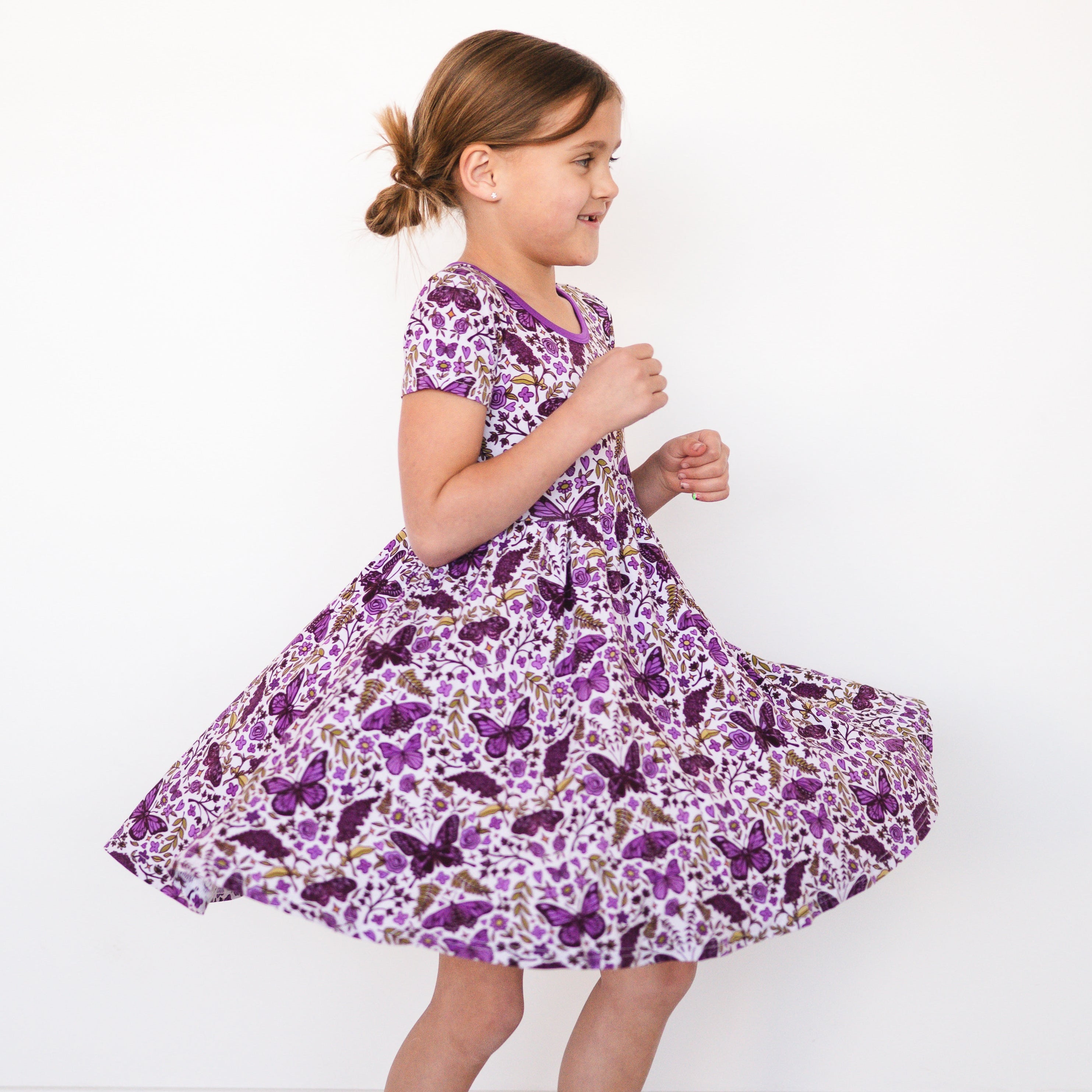 Girl in a purple butterfly print dress.