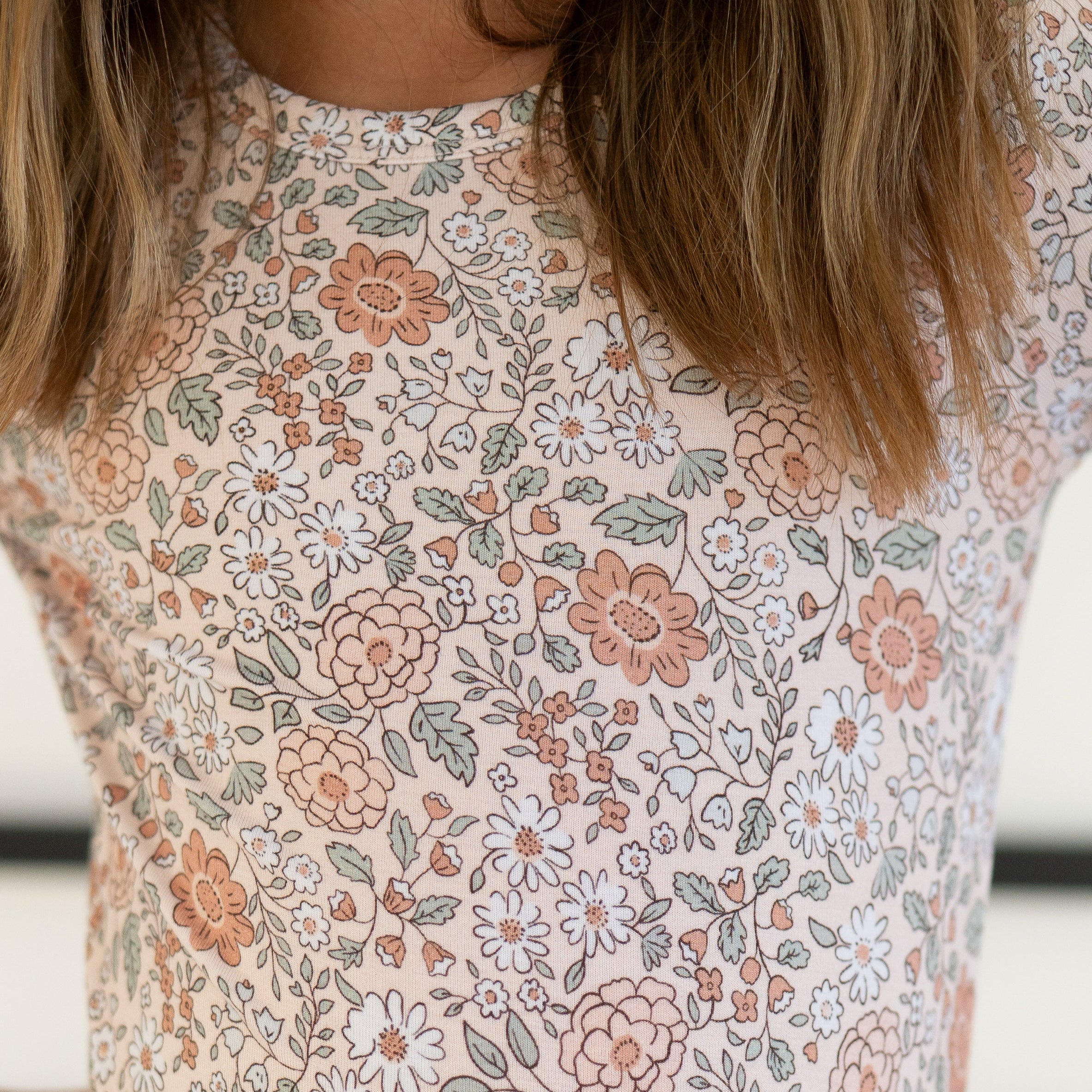 A light pink pajama set with a vintage floral print.