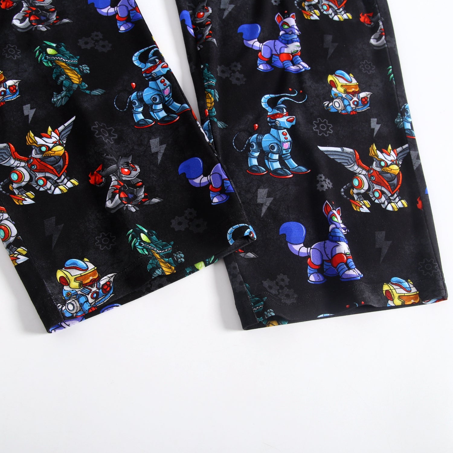 Unisex adult sleep pants with a black background and a repeating pattern of colorful robot characters.