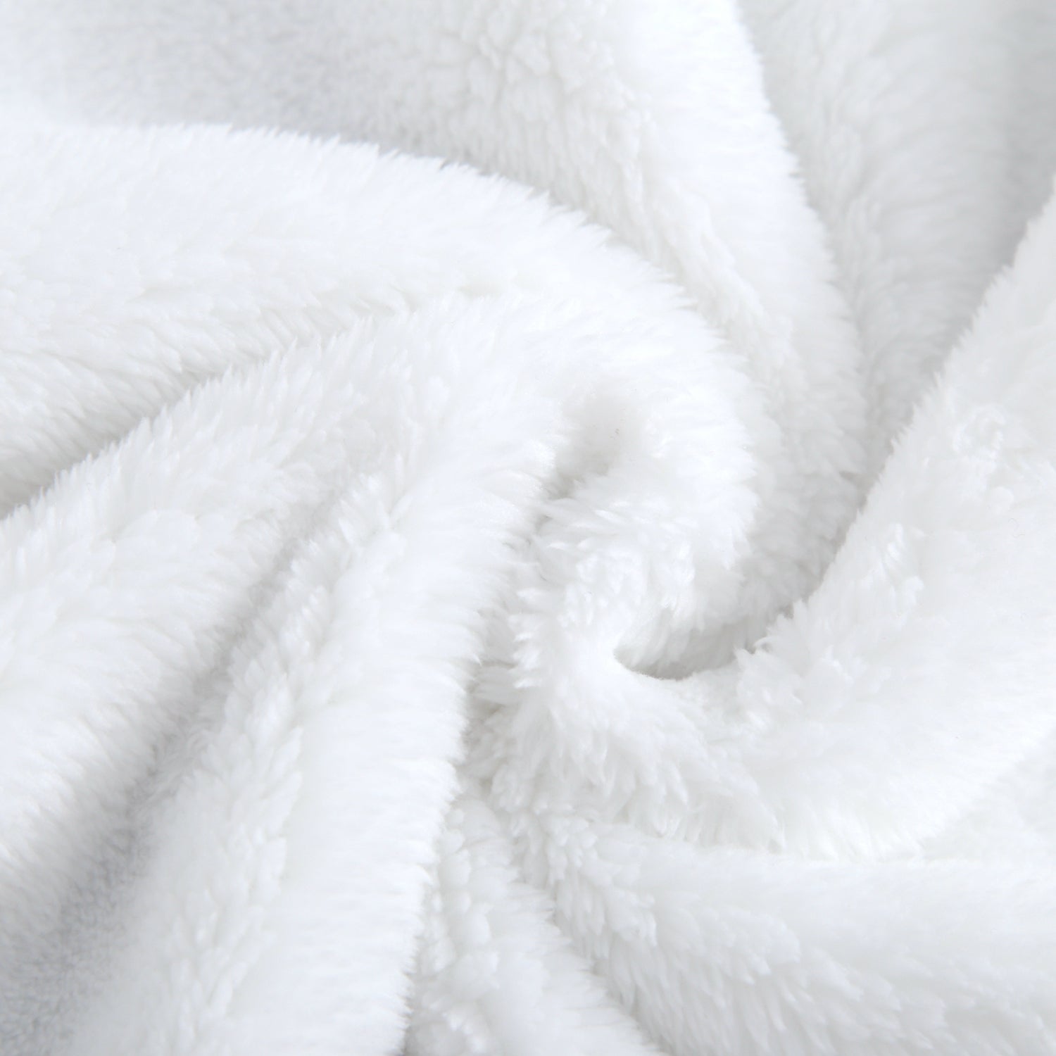 A close-up of a soft, white plush blanket with swirling folds.