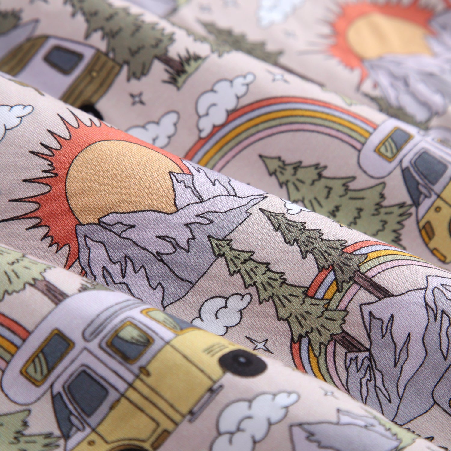 A soft bamboo blanket with a vintage camper, mountain, and rainbow print.