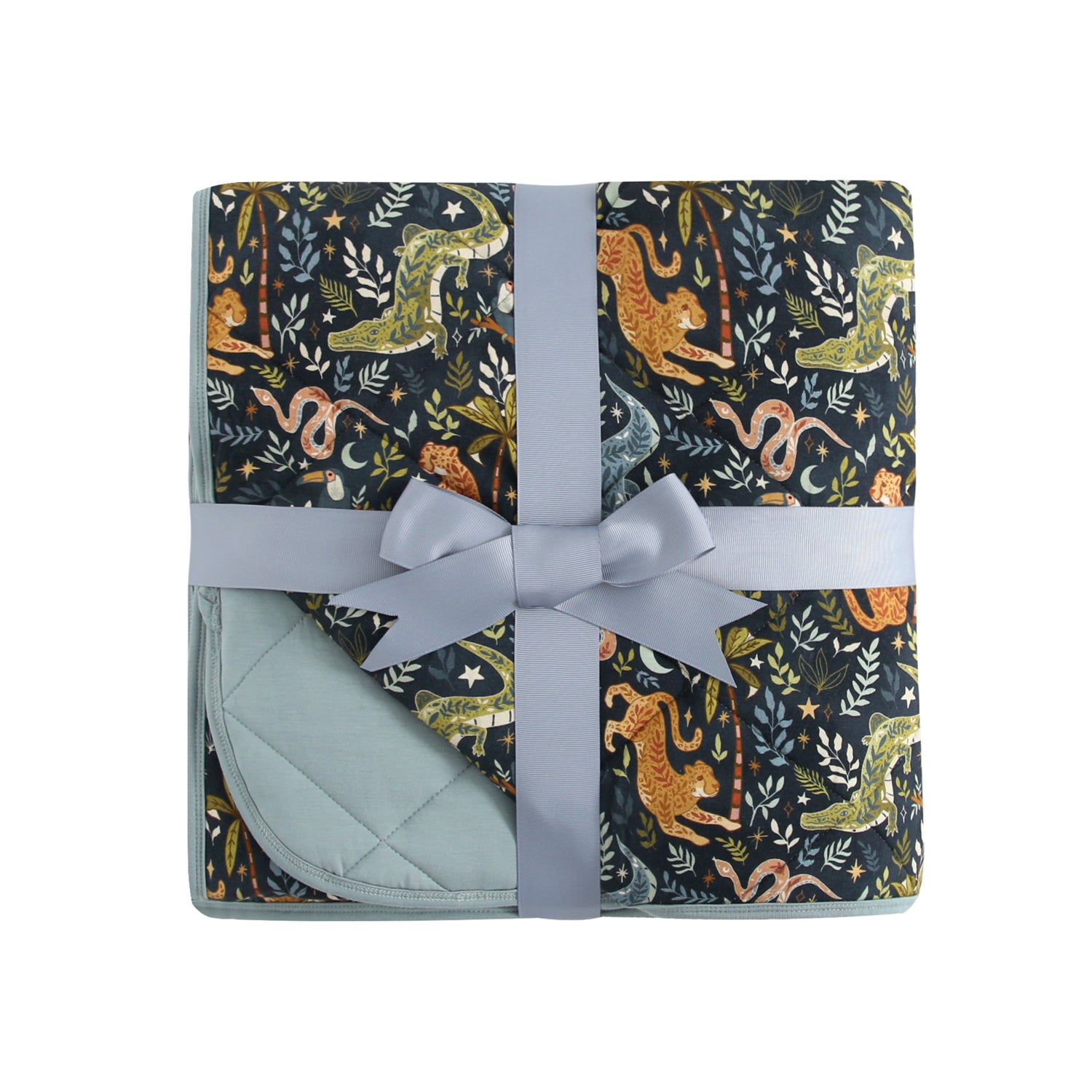 A quilted blanket with a dark jungle print featuring animals and plants, tied with a light blue ribbon.
