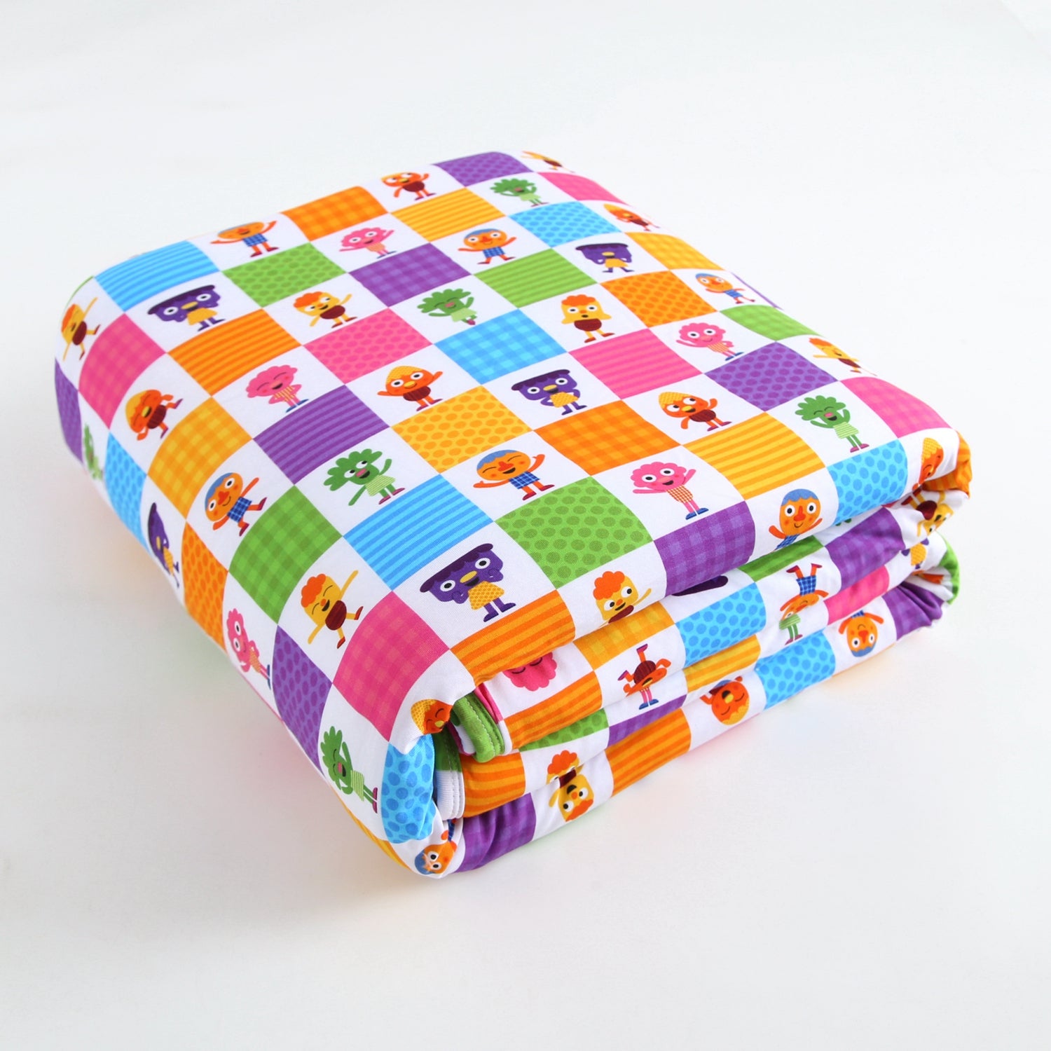 A folded blanket with a colorful checkered pattern featuring cartoon characters.