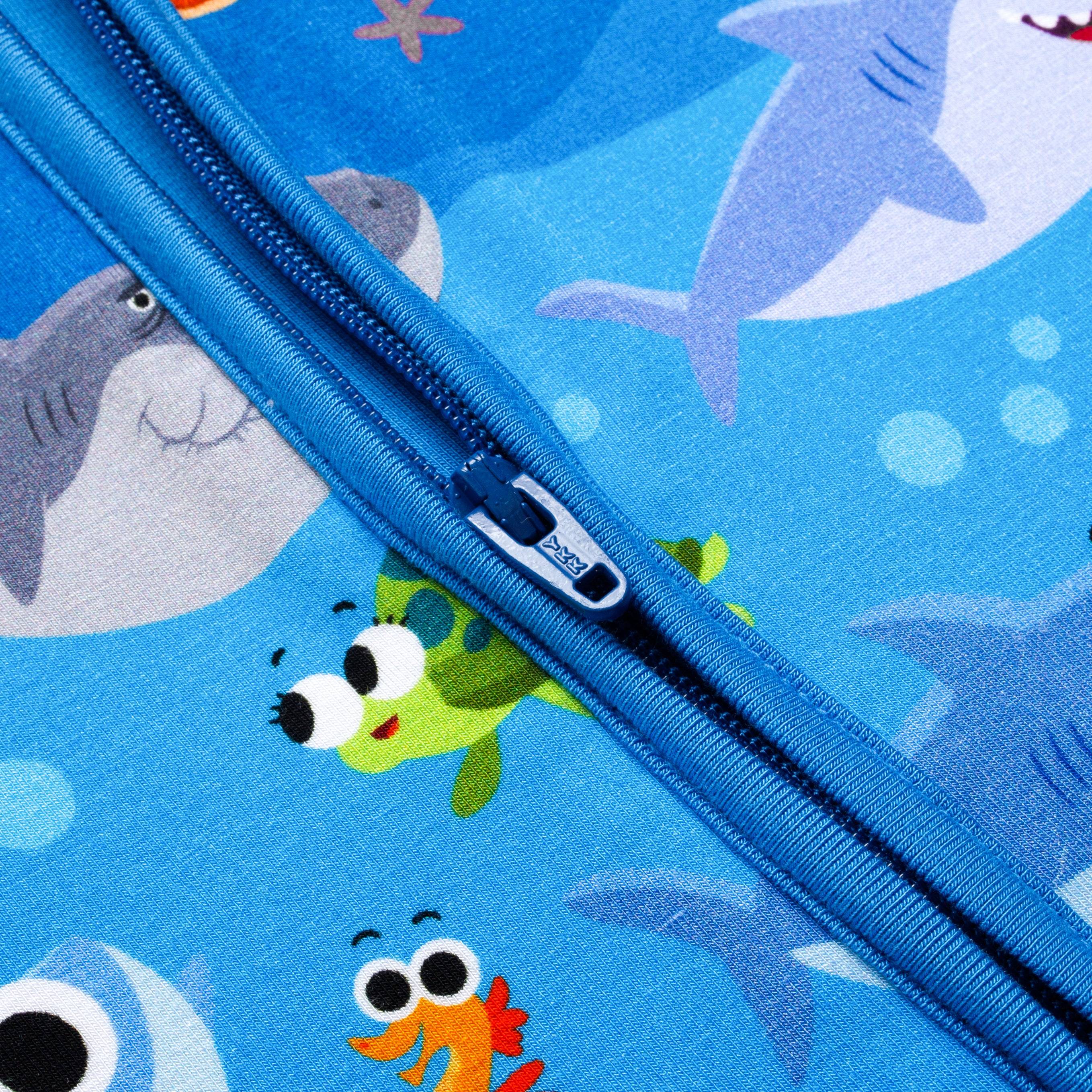 Blue bamboo pajamas with a zipper and a print of sharks and sea creatures.
