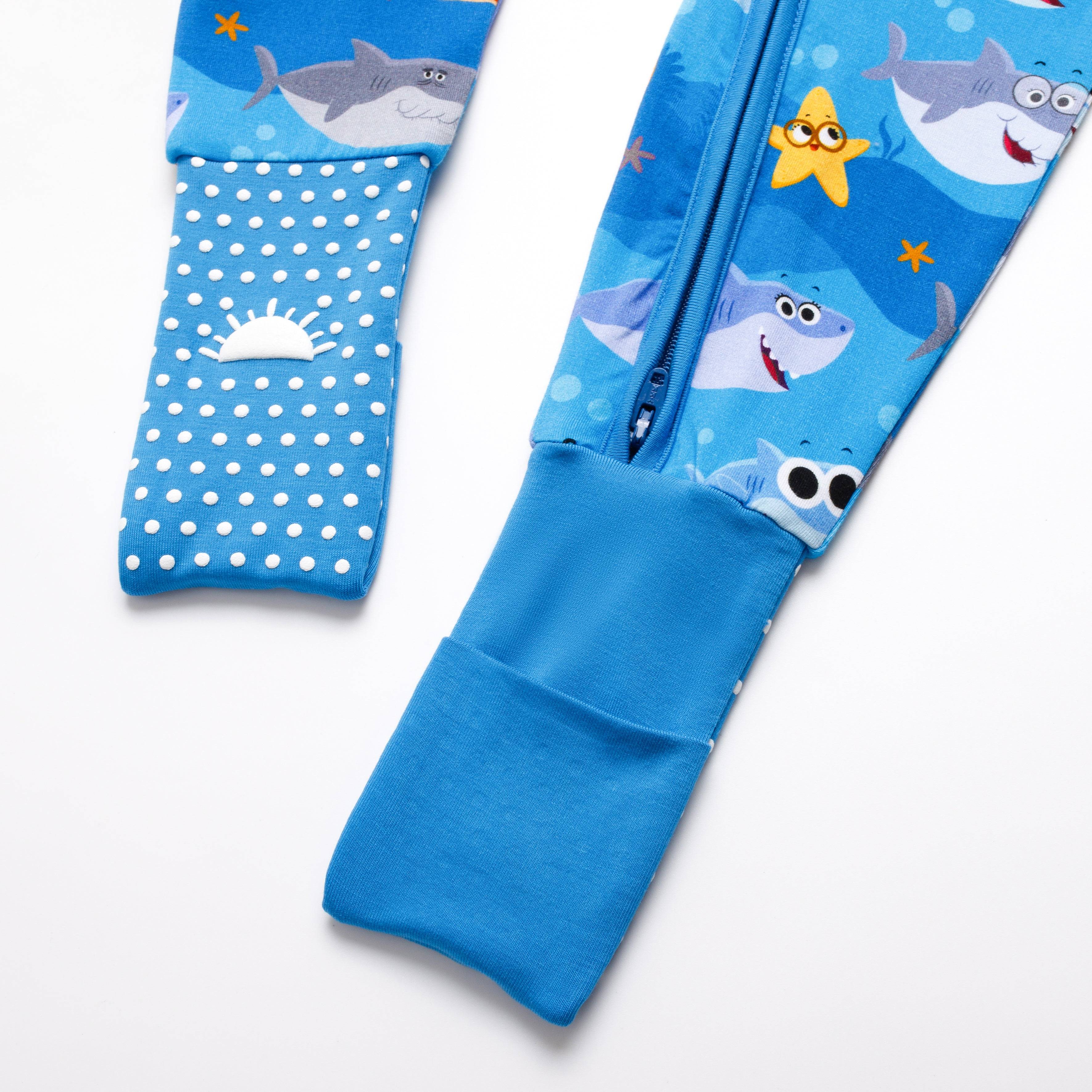 Blue bamboo pajamas with a baby shark print and white polka dots.