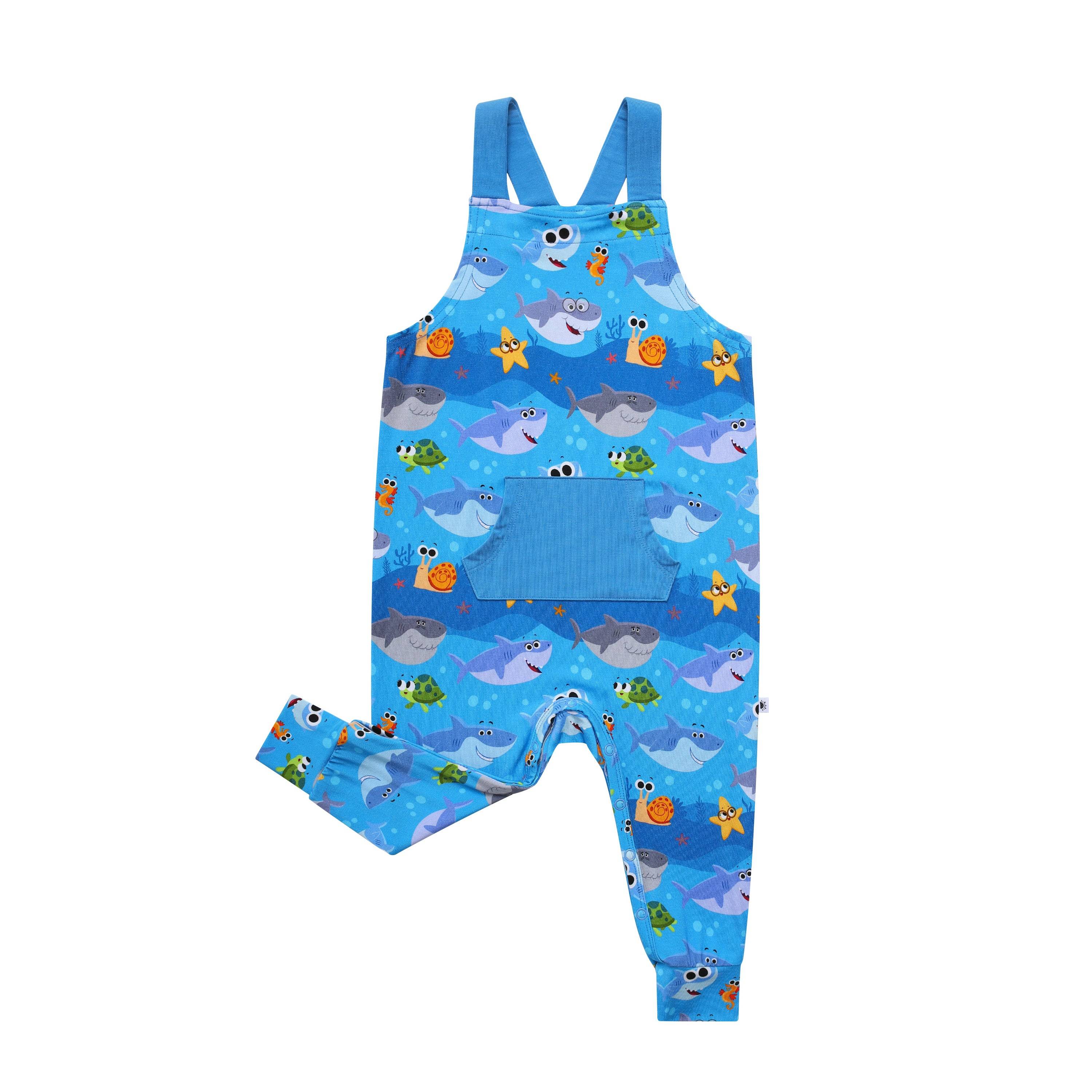 Blue baby overalls with a Baby Shark print and a front pocket.