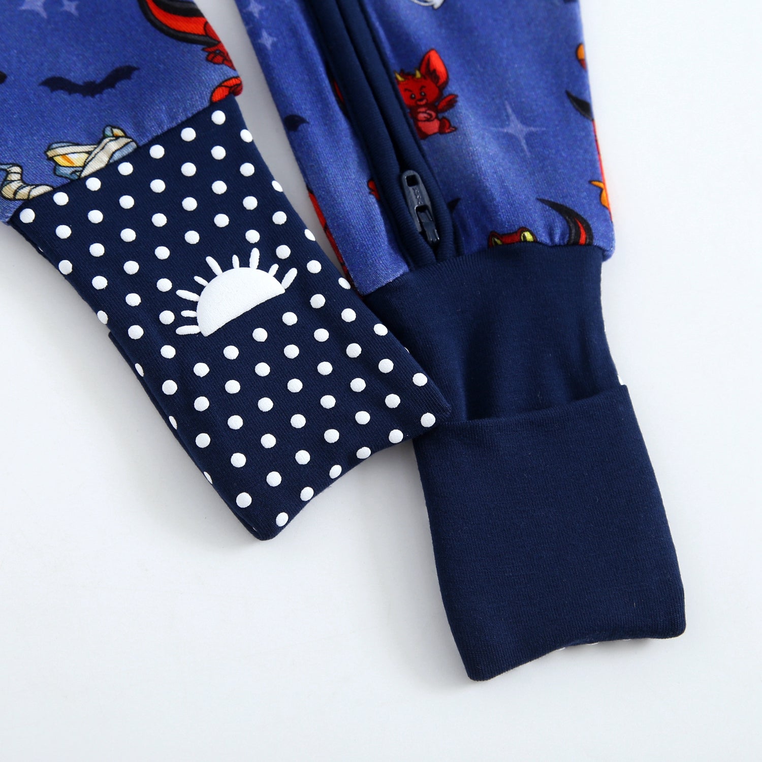 Blue Halloween pajamas with a zipper and polka dot accents.