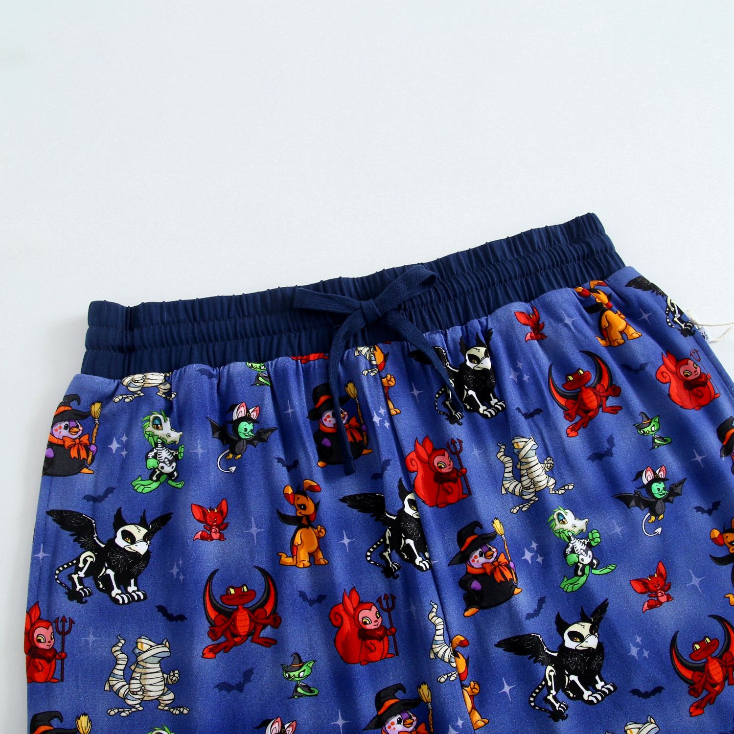 Blue pajama pants with a Halloween-themed Neopets print.