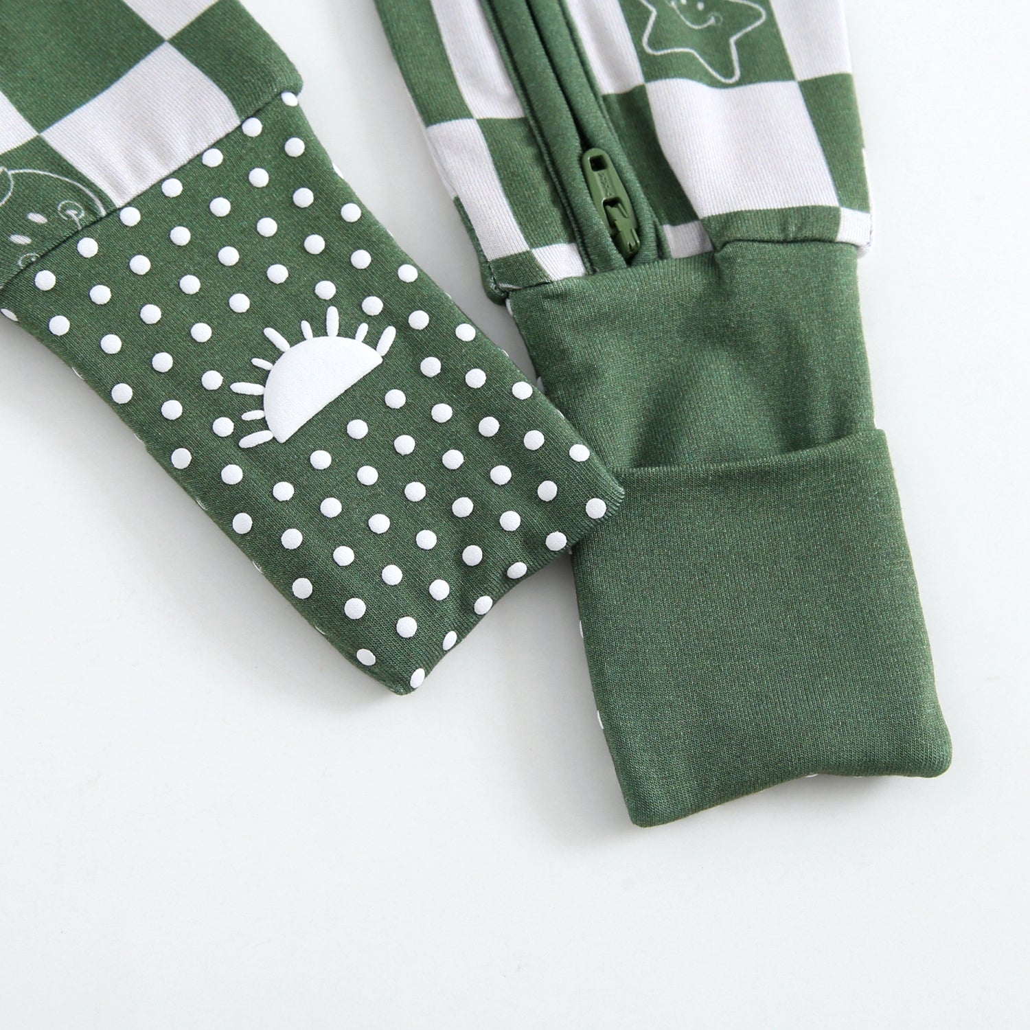 Green bamboo pajamas with white polka dots and a sun graphic.