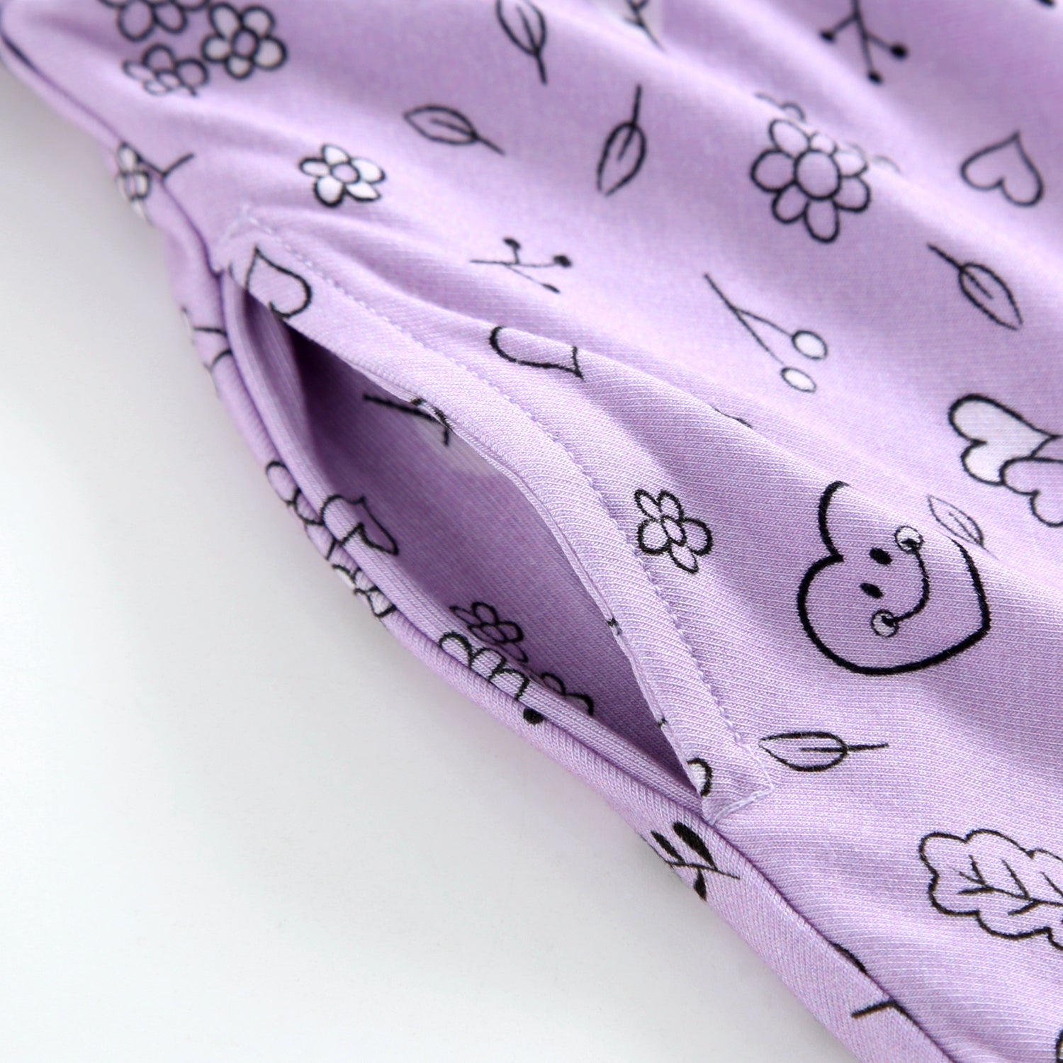 Lilac bamboo dress with a smiley doodle print and a pocket.