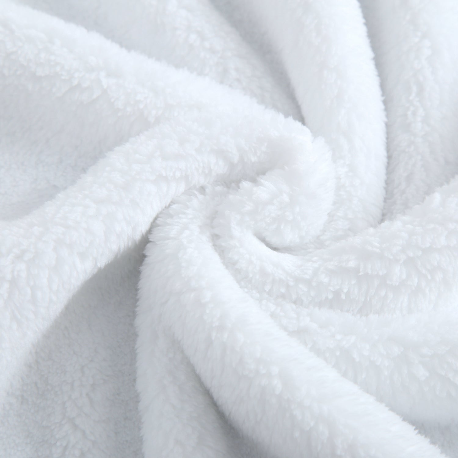 A white plush blanket with soft folds and textures.