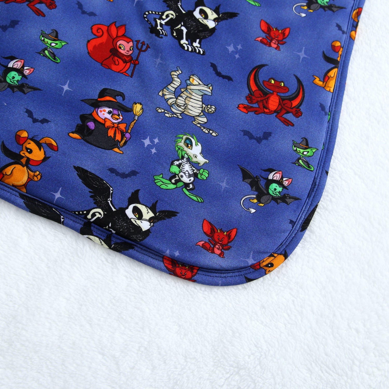 A blue blanket with a Halloween Neopets print.