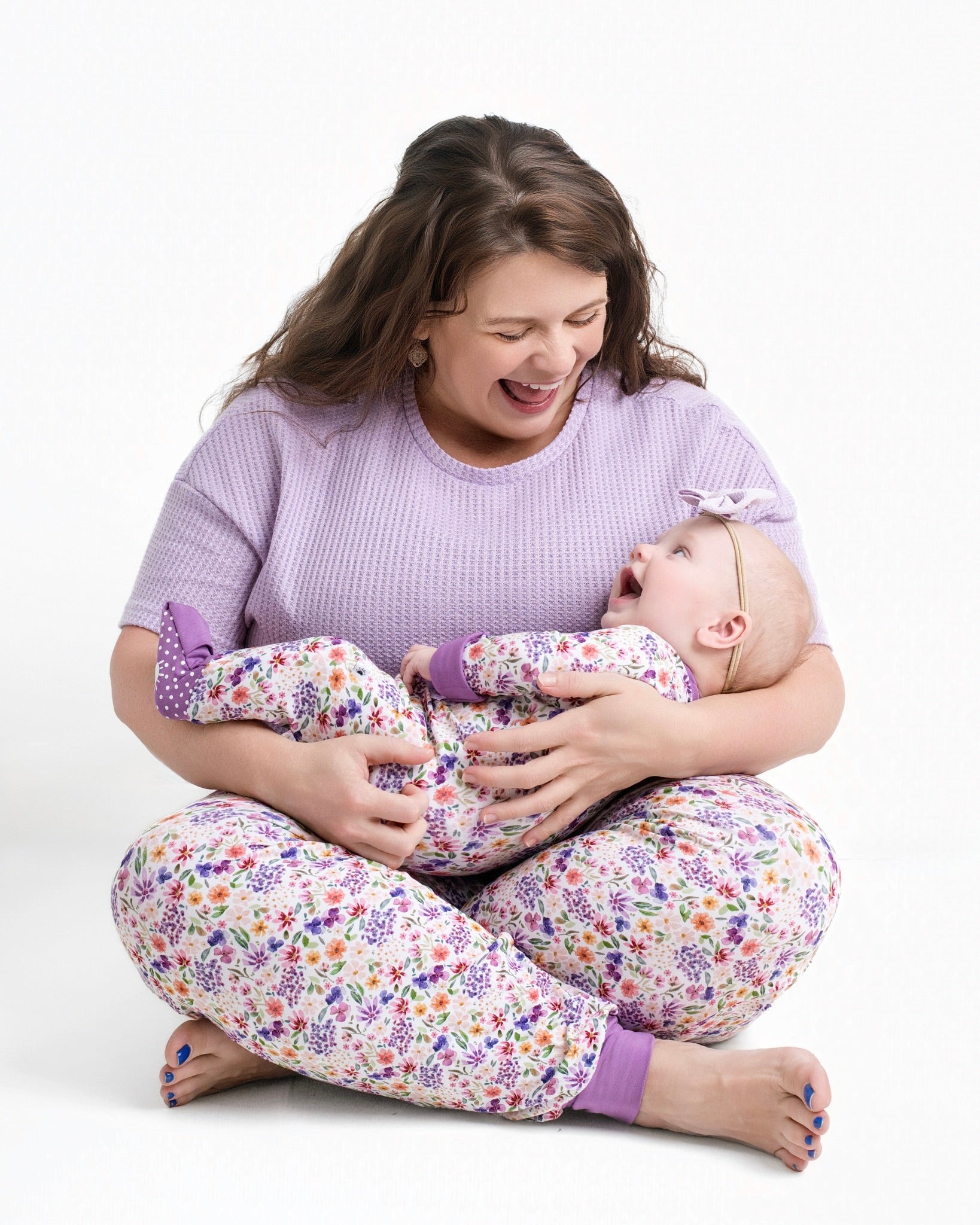 Women's floral print bamboo joggers with a purple top.