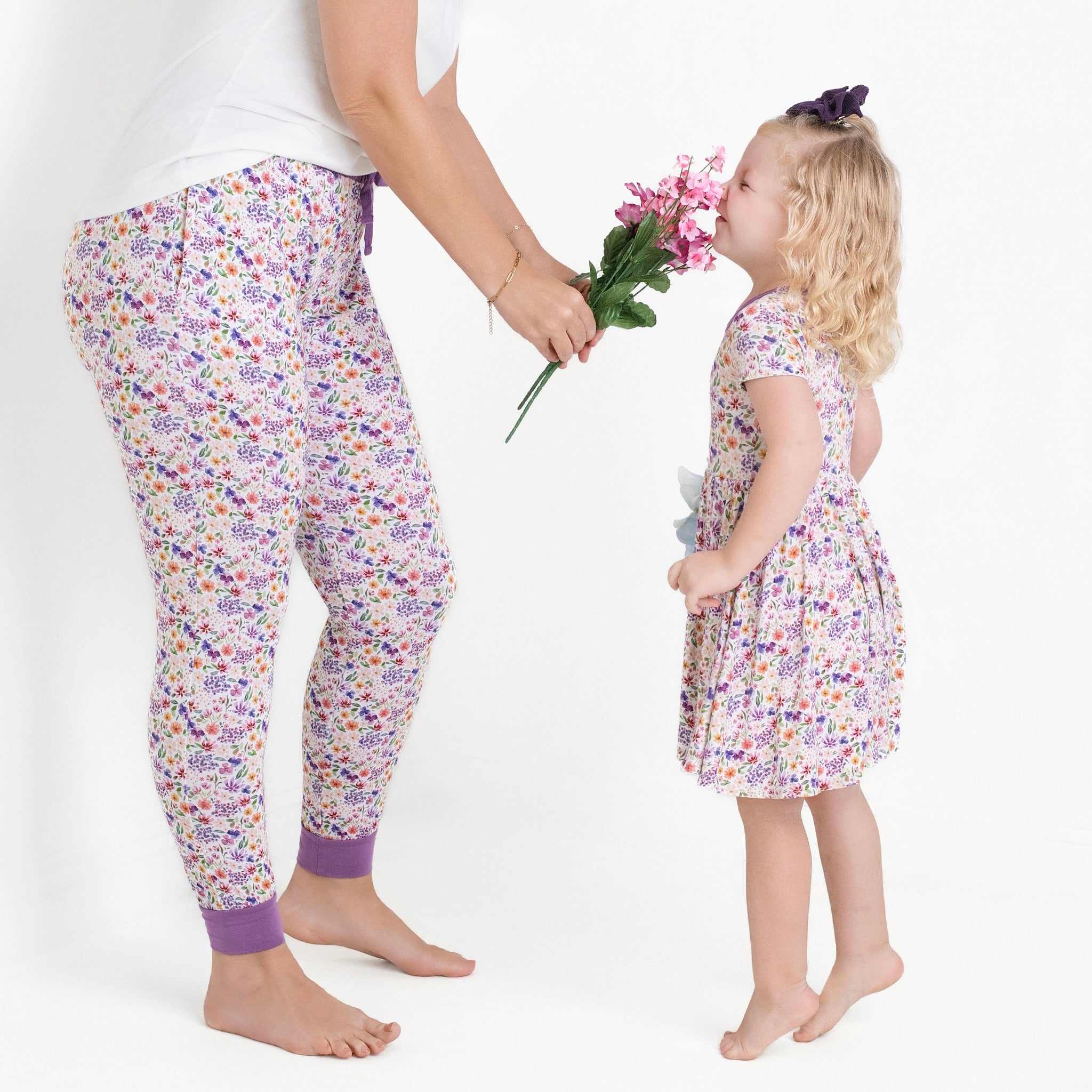 Women's floral print bamboo joggers with purple cuffs.