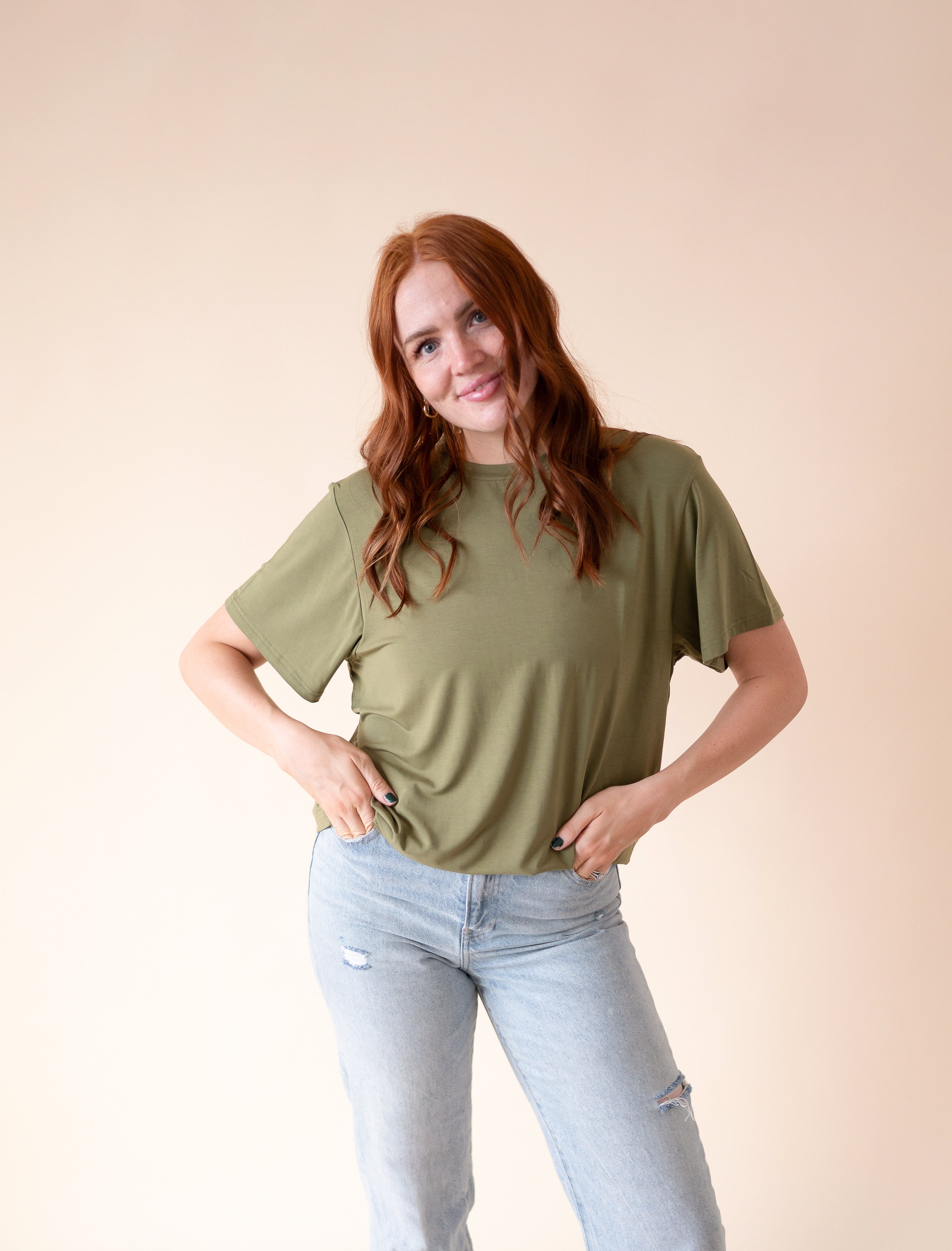Oversized olive green tencel modal tee with light wash distressed jeans.