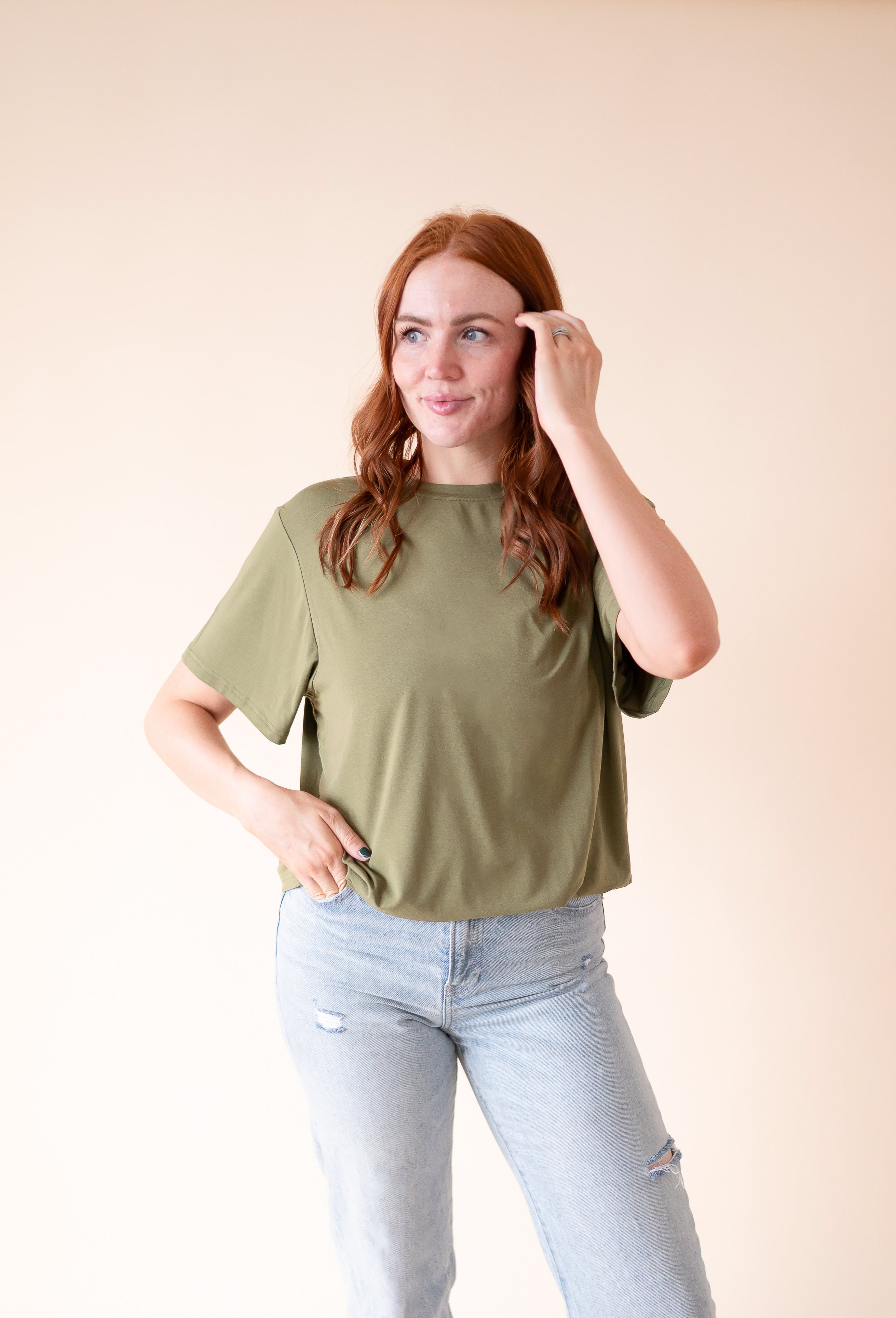 Oversized olive green tencel modal t-shirt with light wash distressed jeans.