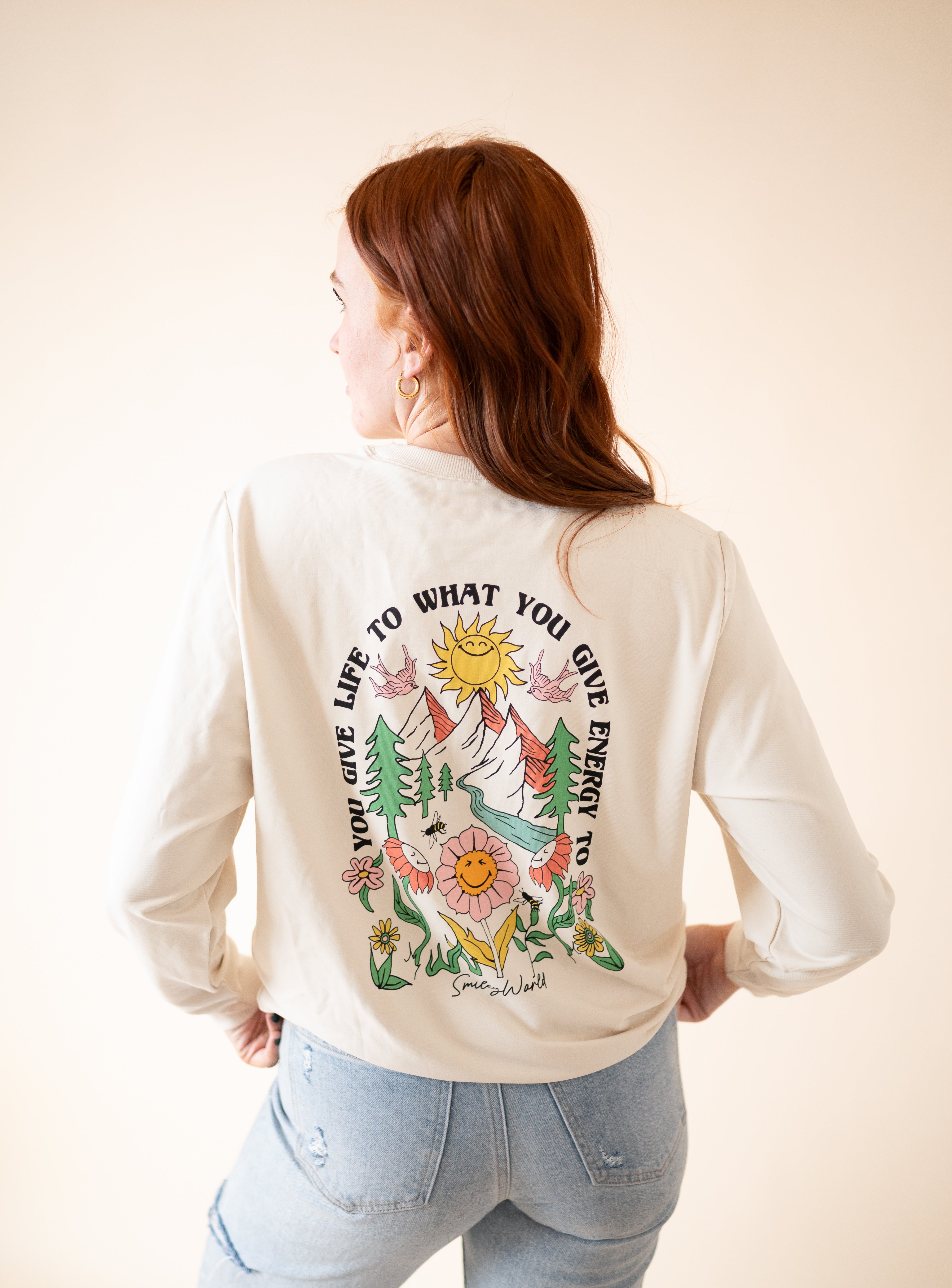 Adult unisex crewneck sweatshirt with SmileyWorld graphic.