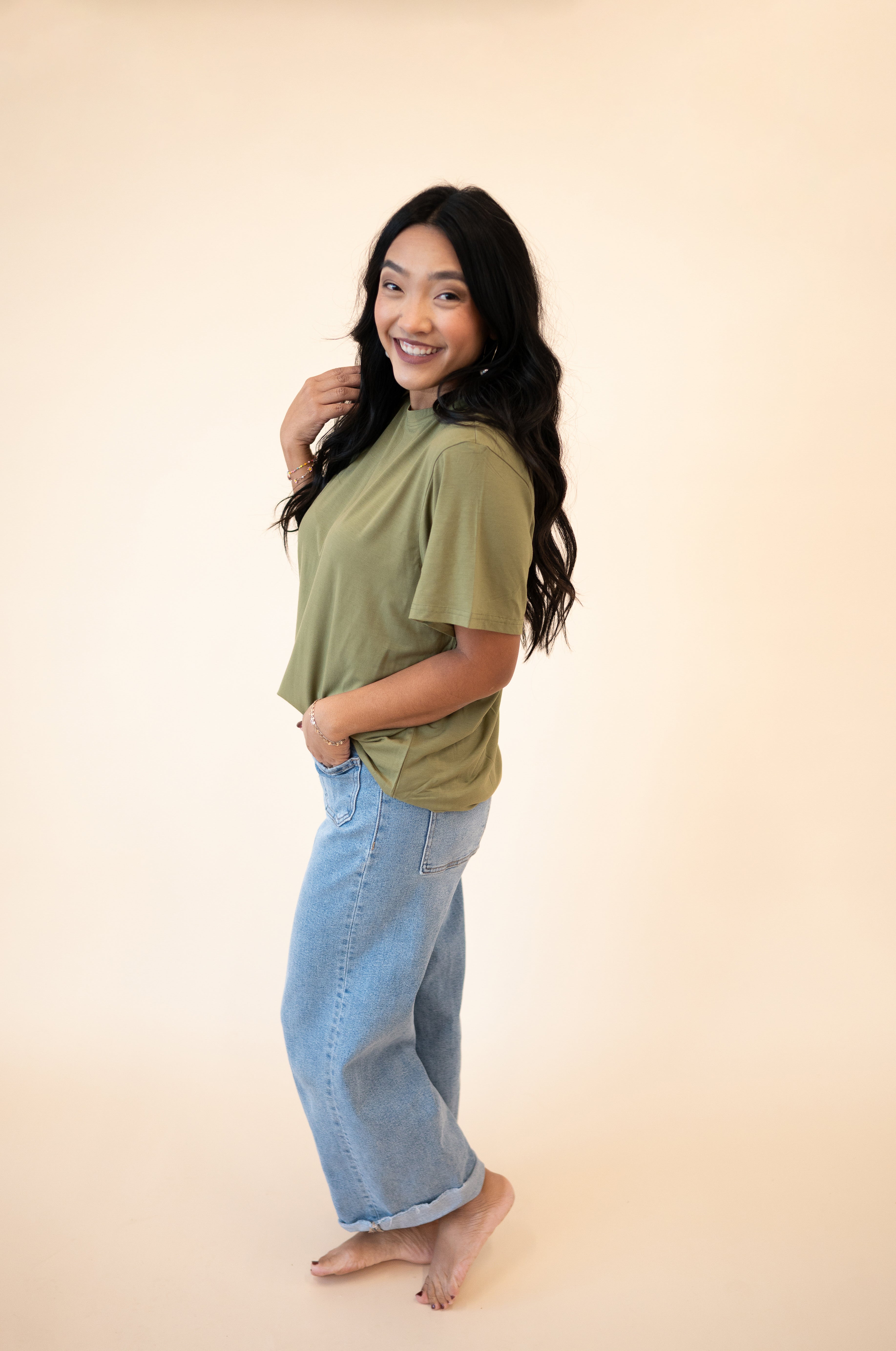 Oversized olive green tencel modal t-shirt with light wash jeans.