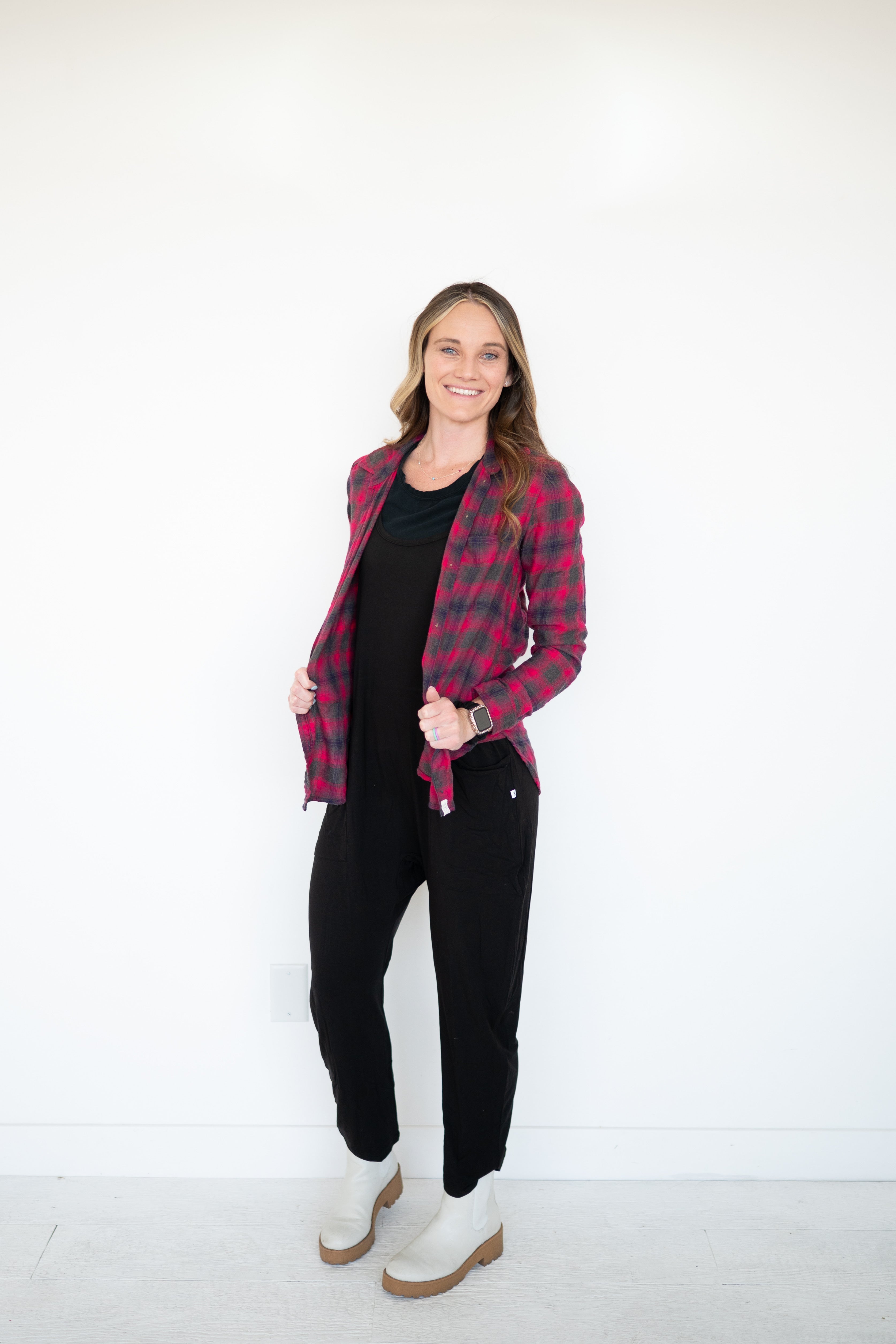 Black bamboo overalls with a red and grey plaid shirt and white boots.