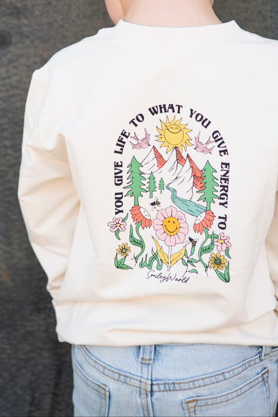 Cream crewneck sweatshirt with a colorful SmileyWorld graphic on the back.
